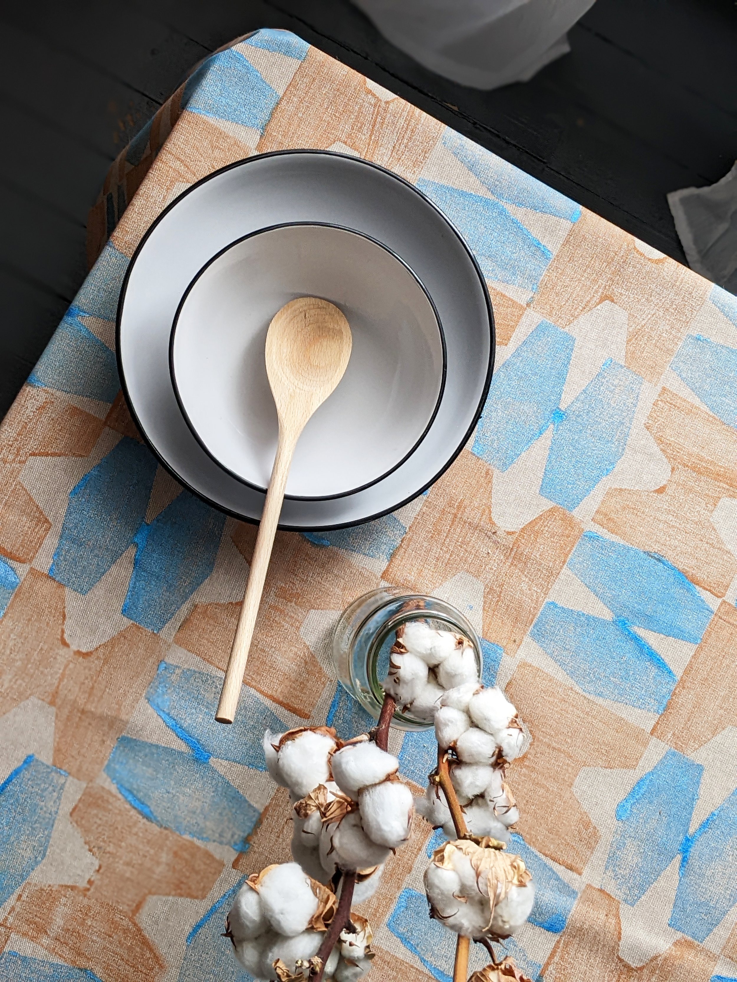 table with hand block printed table cloth in bright blue and bronze
