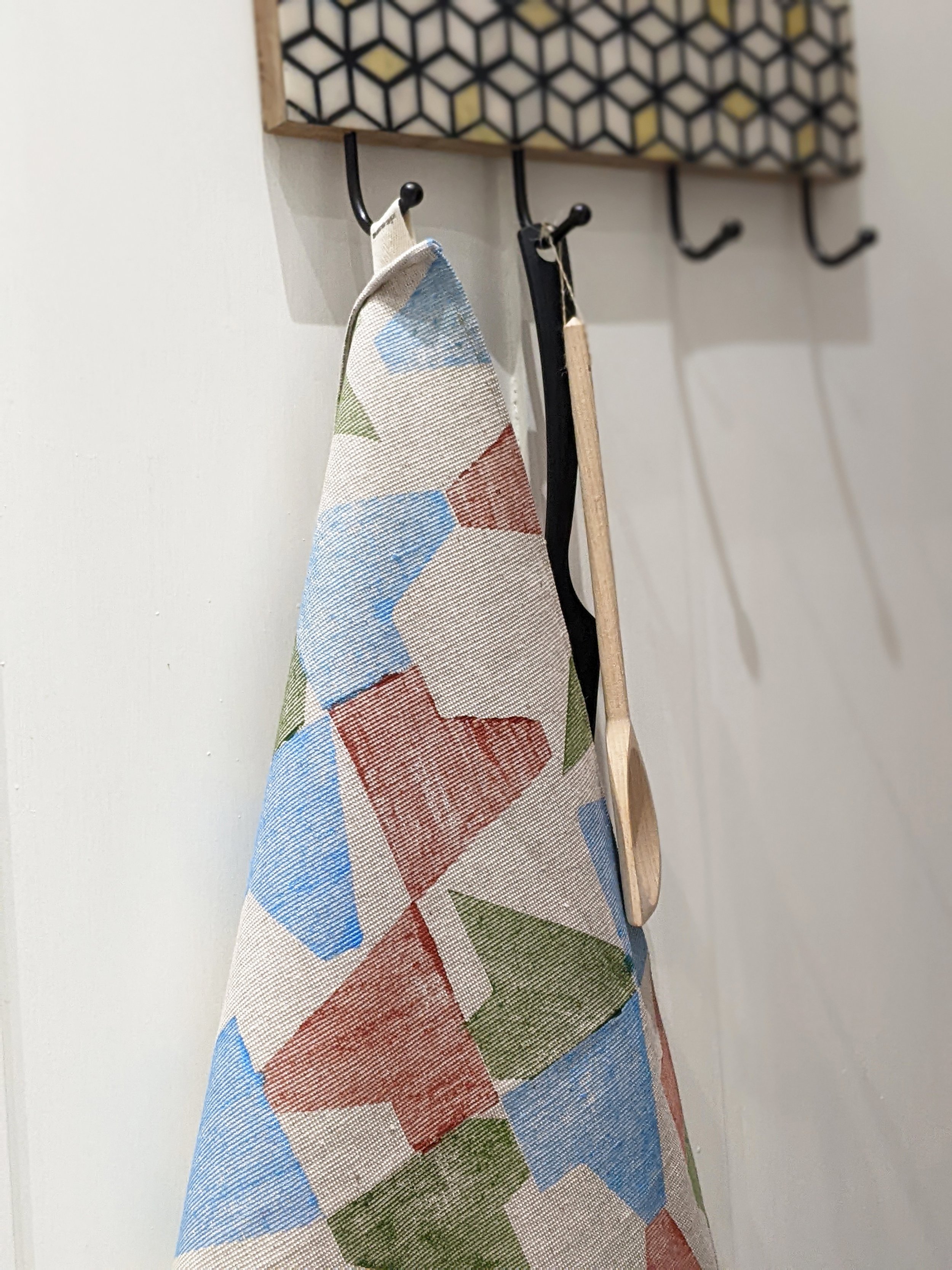 hand block printed geometric teatowel hanging on kitchen door