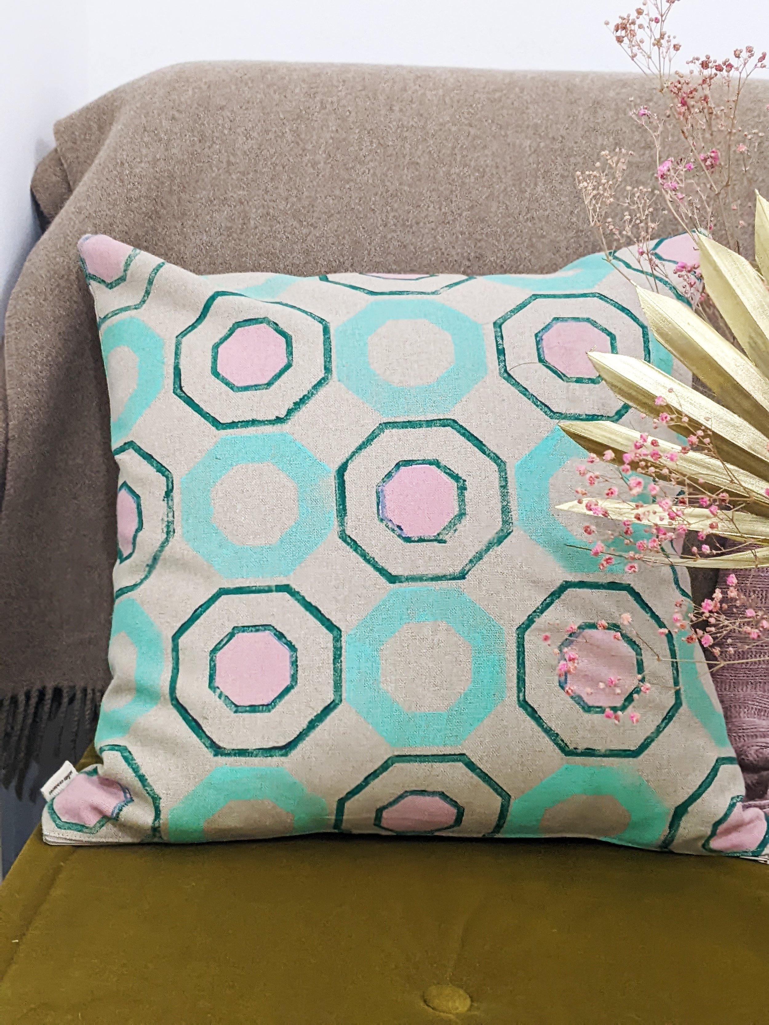 seat with geometric printed cushion and flowers