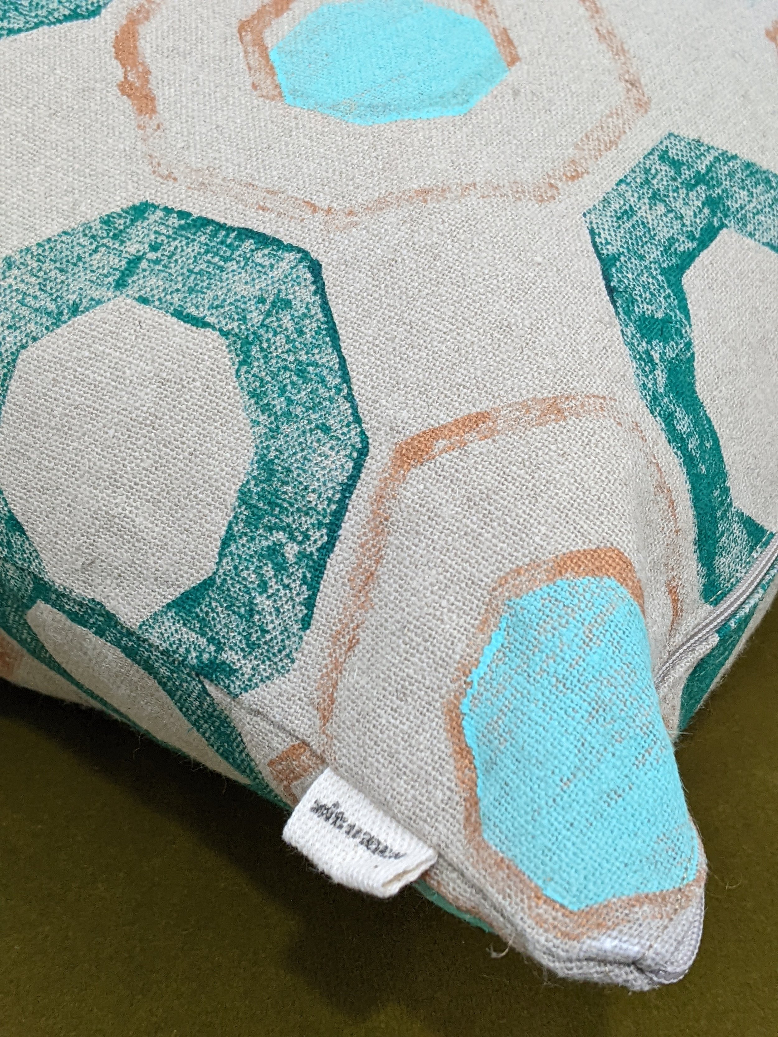close-up detail of hand block printed pattern on boho luxury linen cushion