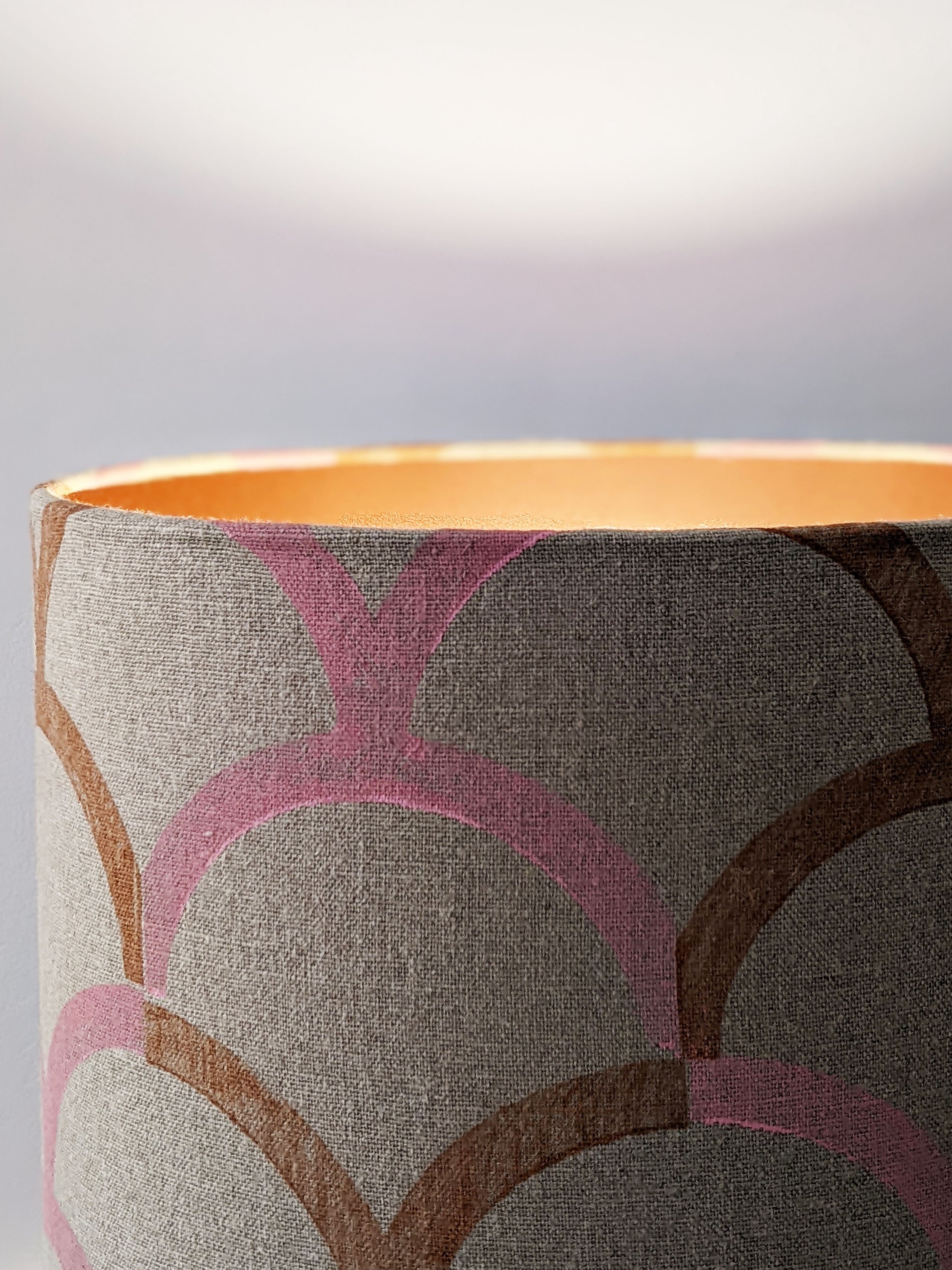 bronze lampshade illuminated with pastel pink vintage inspired pattern