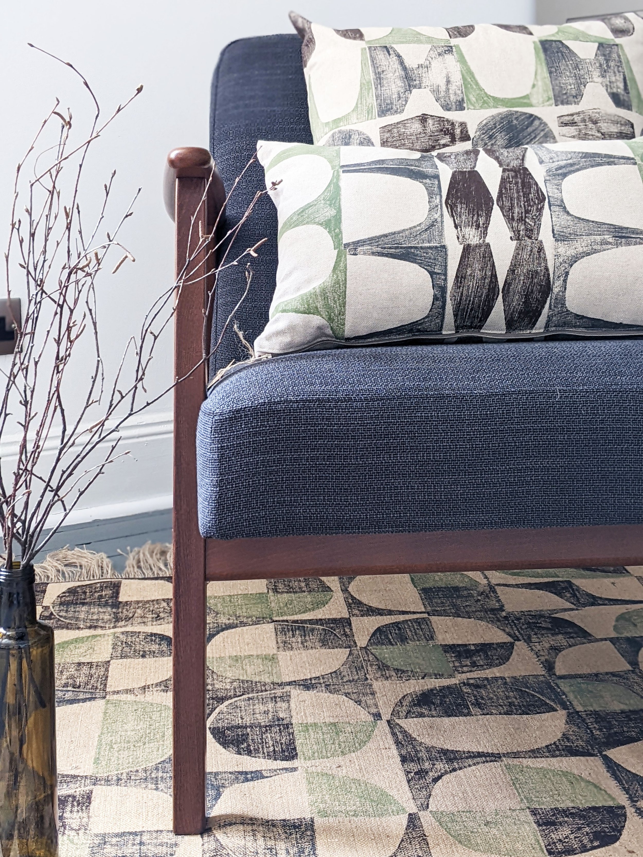 1960s inspired mid-century modern interior scene with hand block printed patterns on cushion and rug