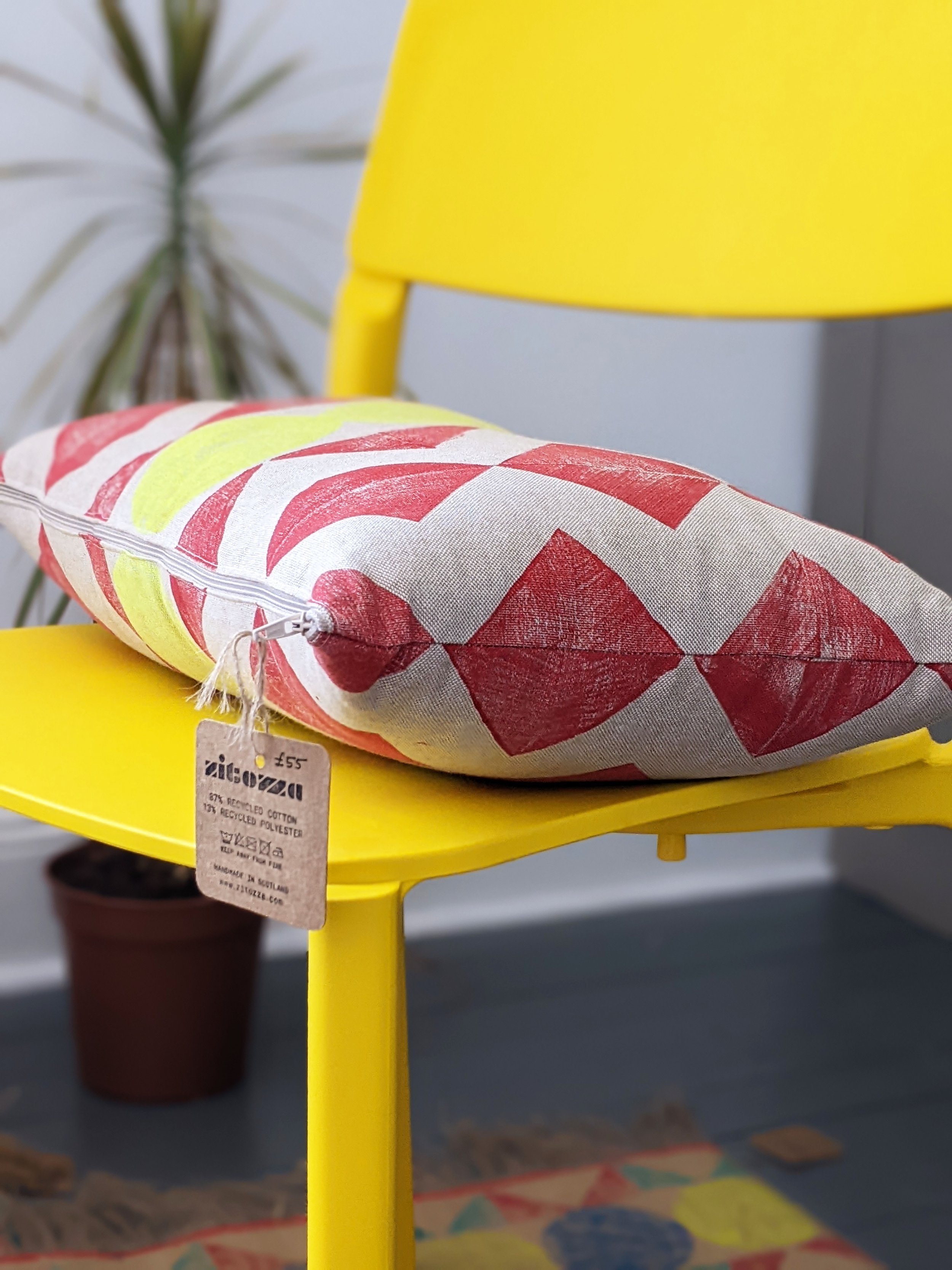 rectangular cushion with hand block printed geometric zigzag patern on yellow chair