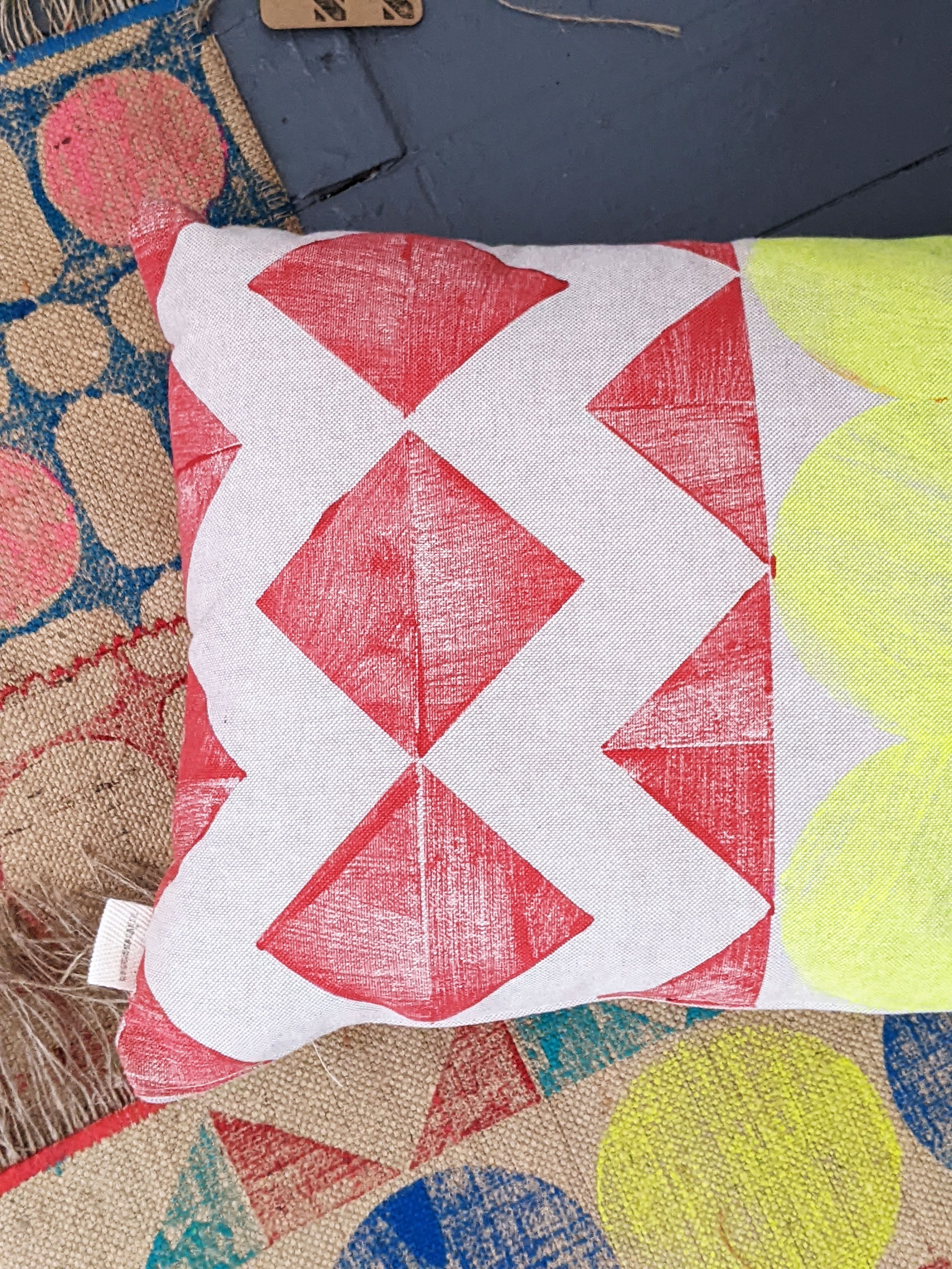 close-up detail of red geometric zigzag pattern on hand block printed cushion