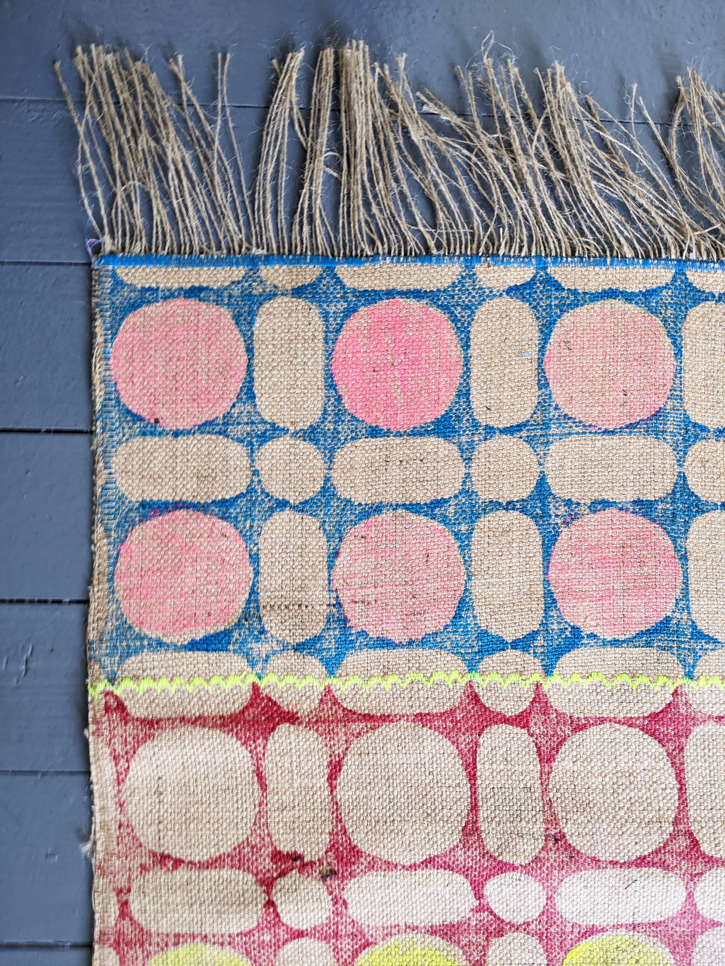 close-up details of block printed, hand stitched, handmade jute rug in contemporary pattern