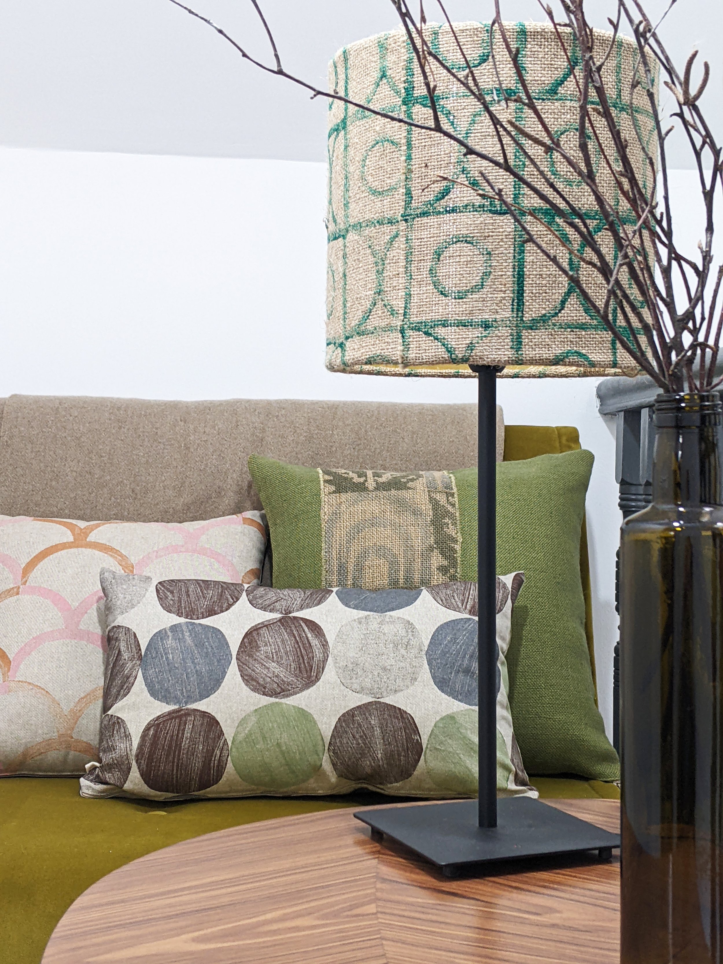 boho interior scene with green geometric prints and pattern clashing details with modern cushion on seat