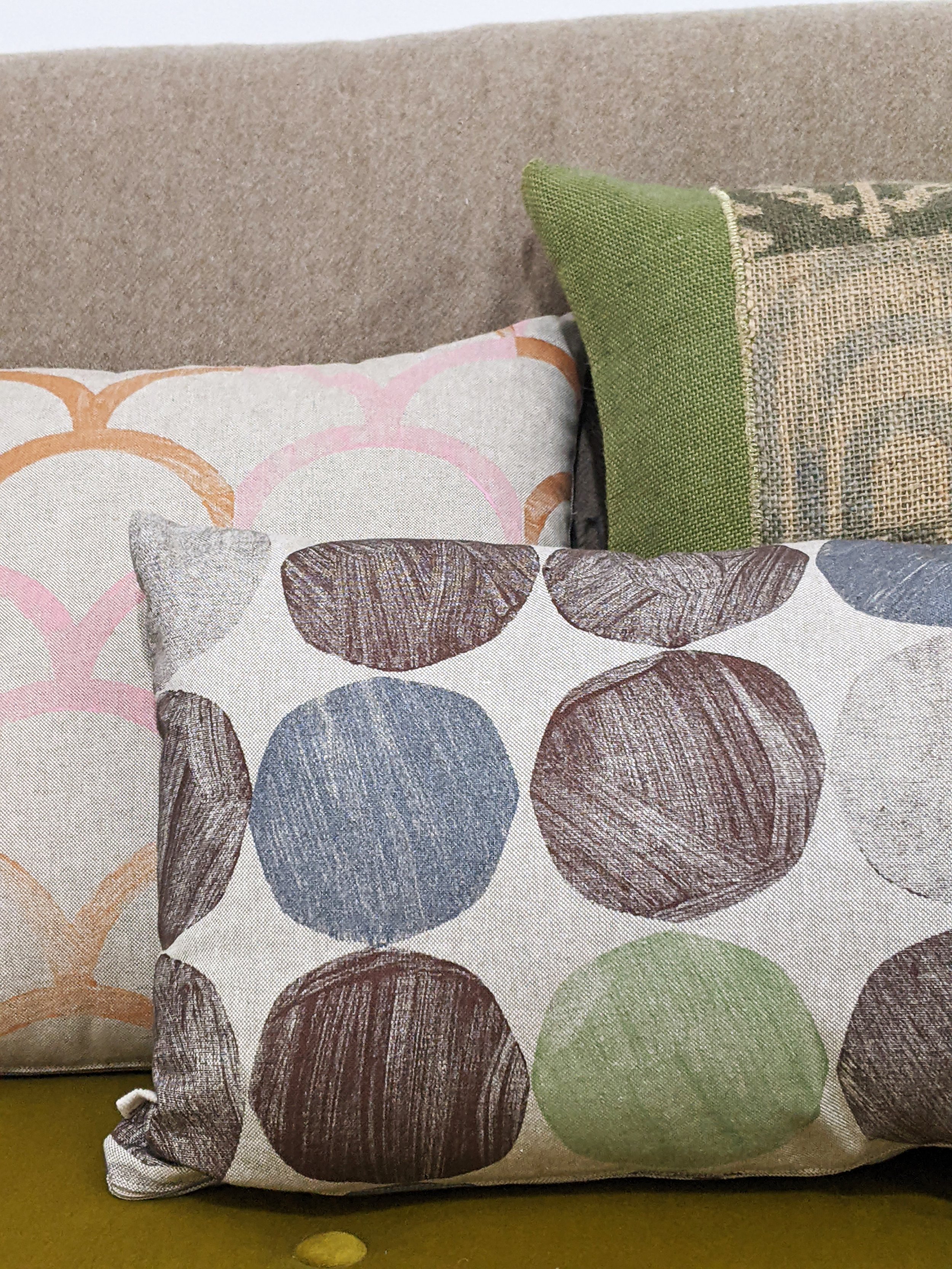 close-up detail of abstract geometric modernism-inspired print on rectangular cushion in boho interior scene