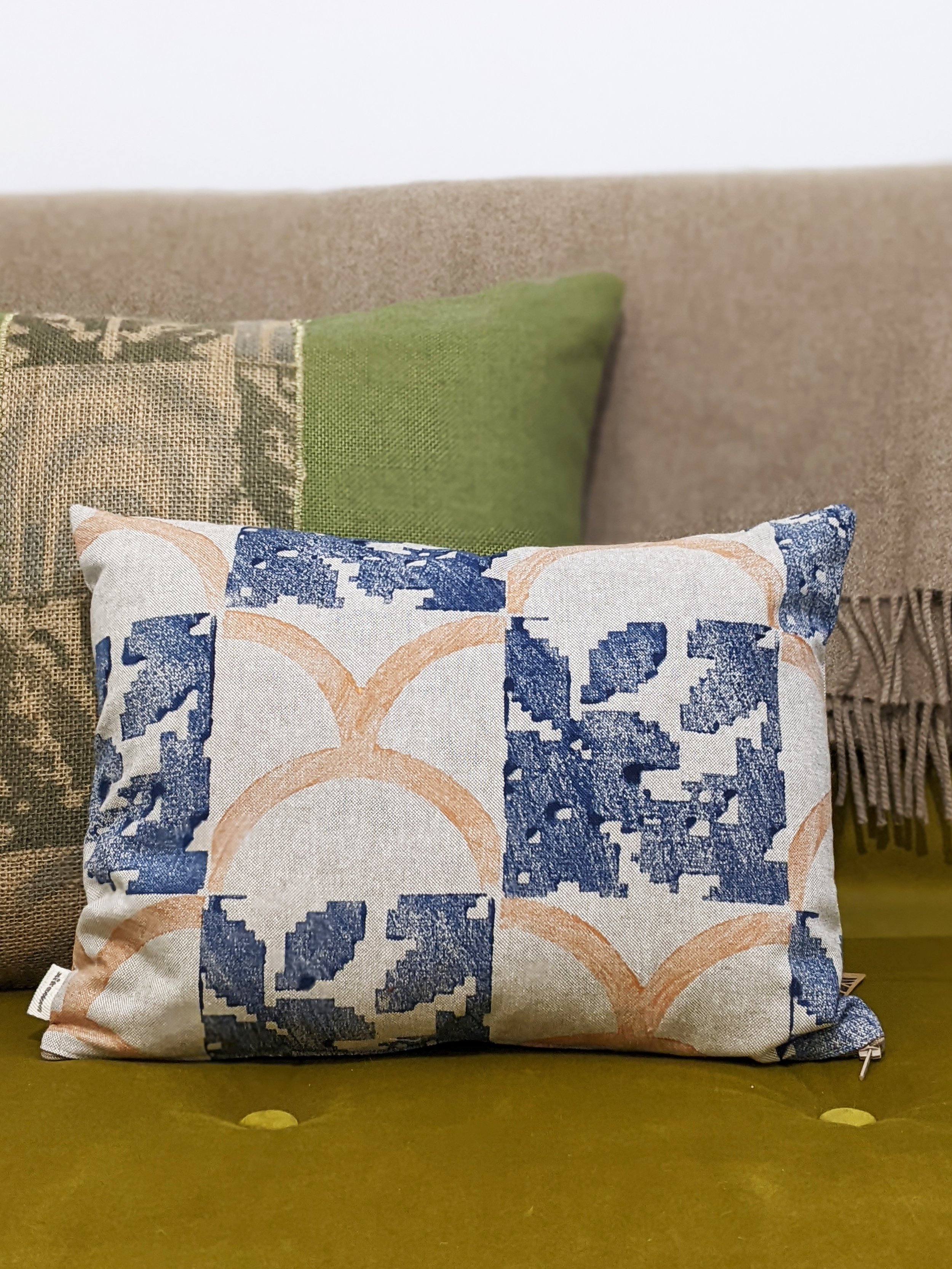 living room scene with seat with rustic printed cushions in earth tones