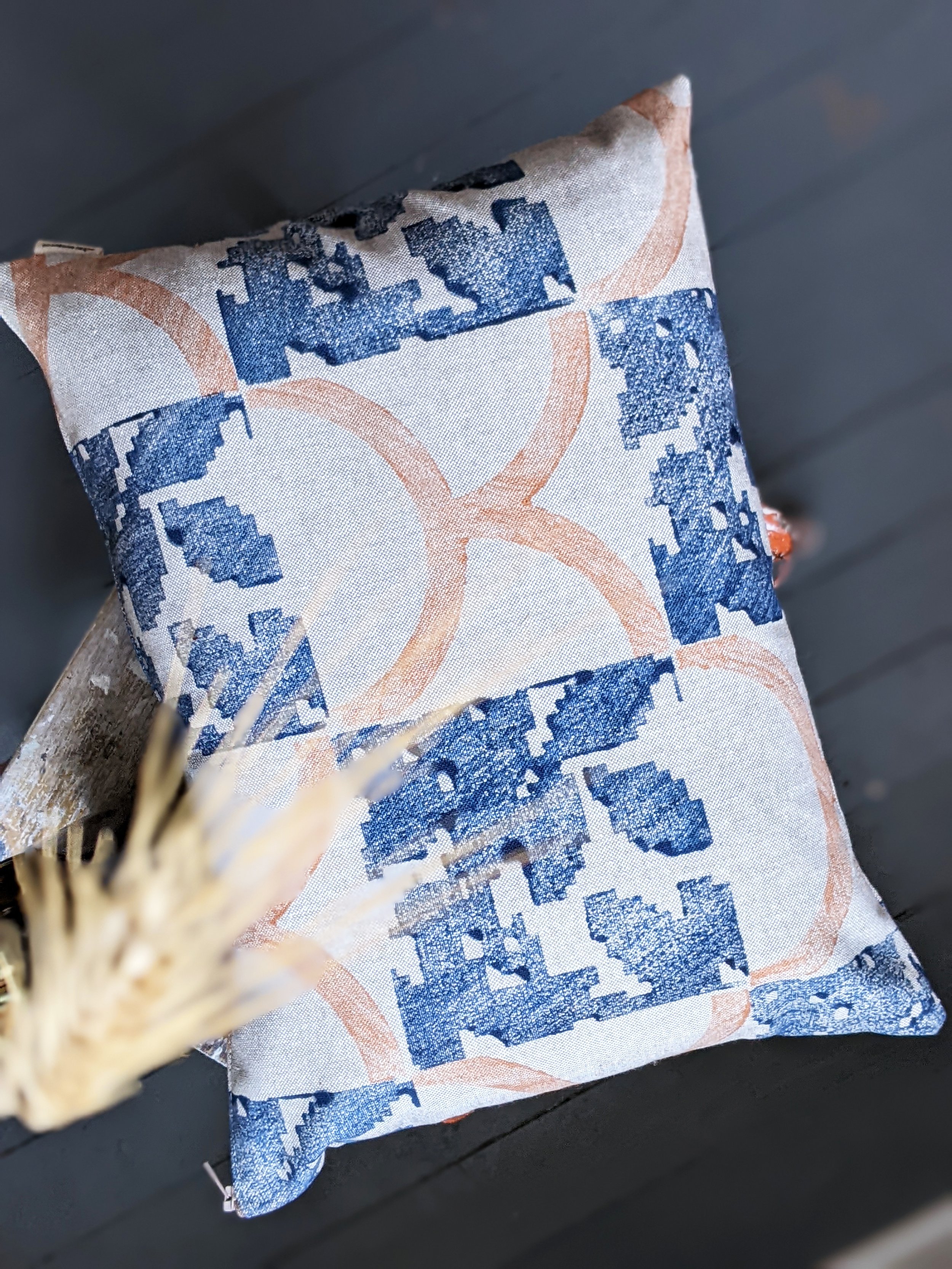 rustic interior scene with block printed small cushion on wooden stool