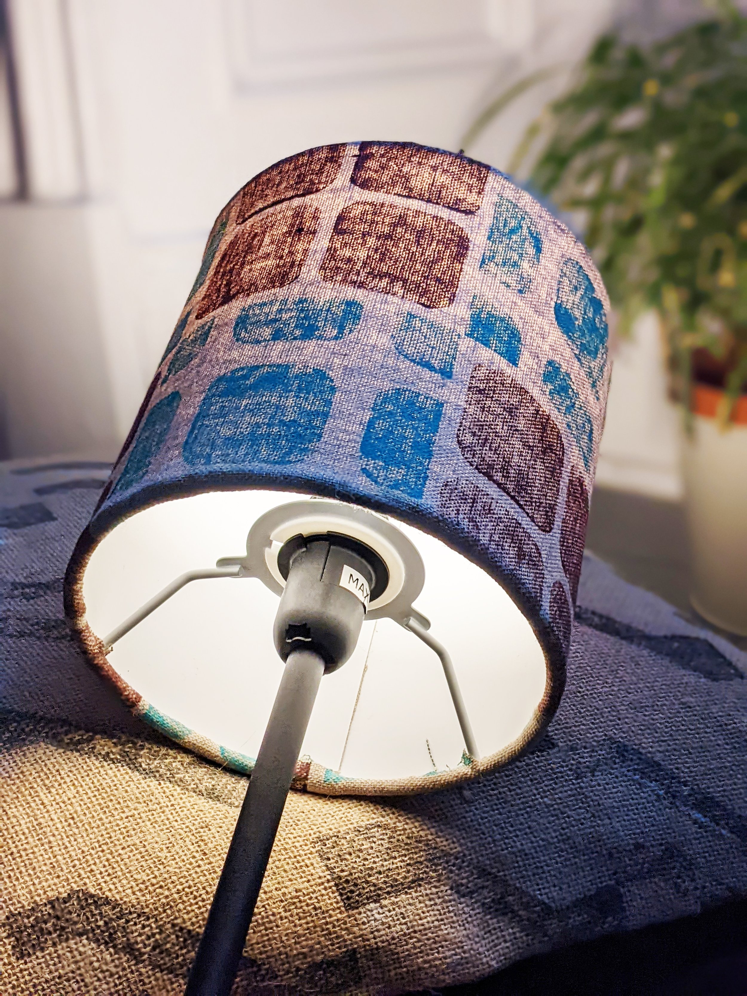 small lampshade on printed jute cushion and rug with hand block printed brutalist pattern