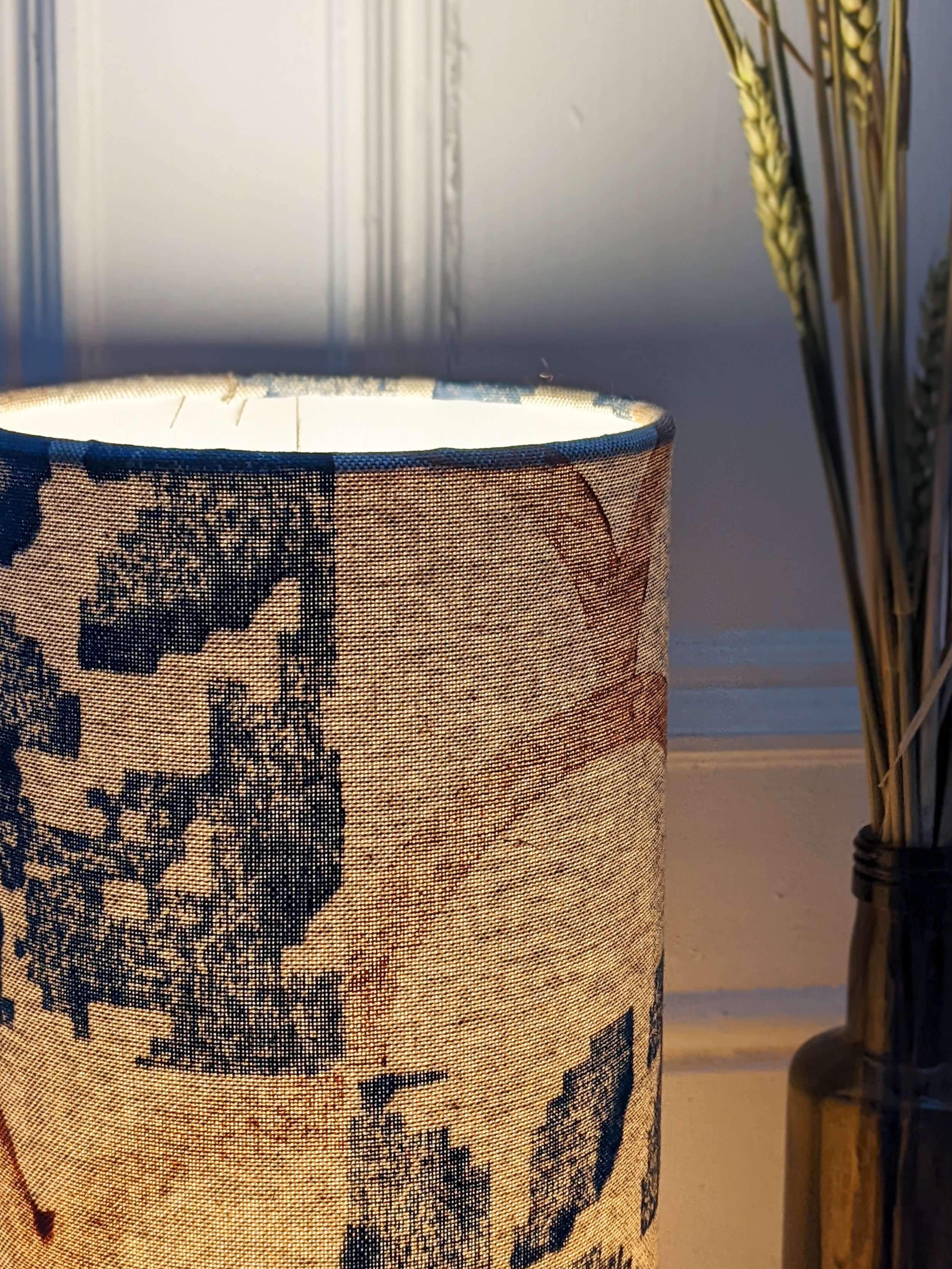 close-up of illuminated floor lamp with botanical pattern