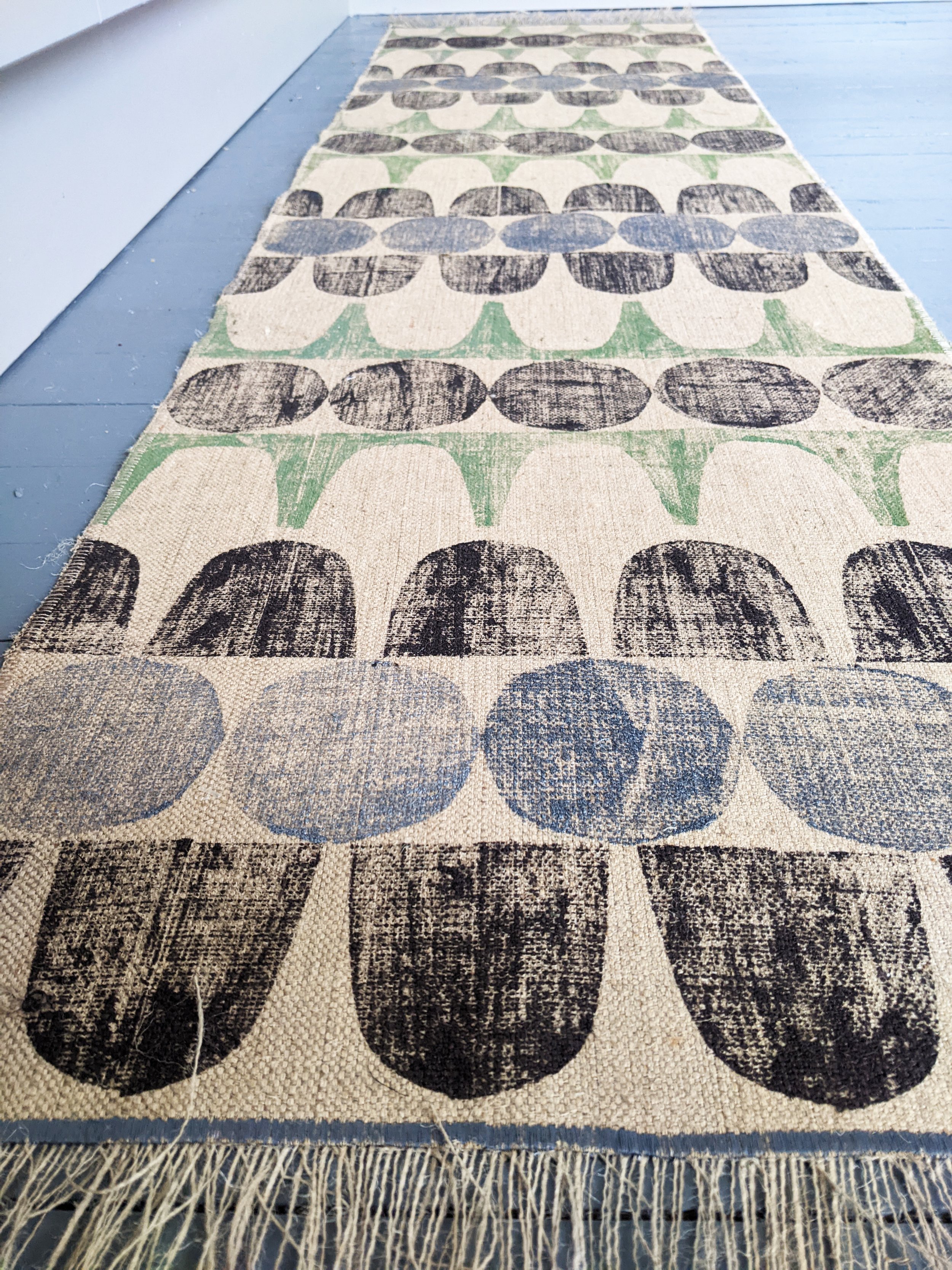 long runner rug on floor with mid-century modern inspired abstract geometric pattern