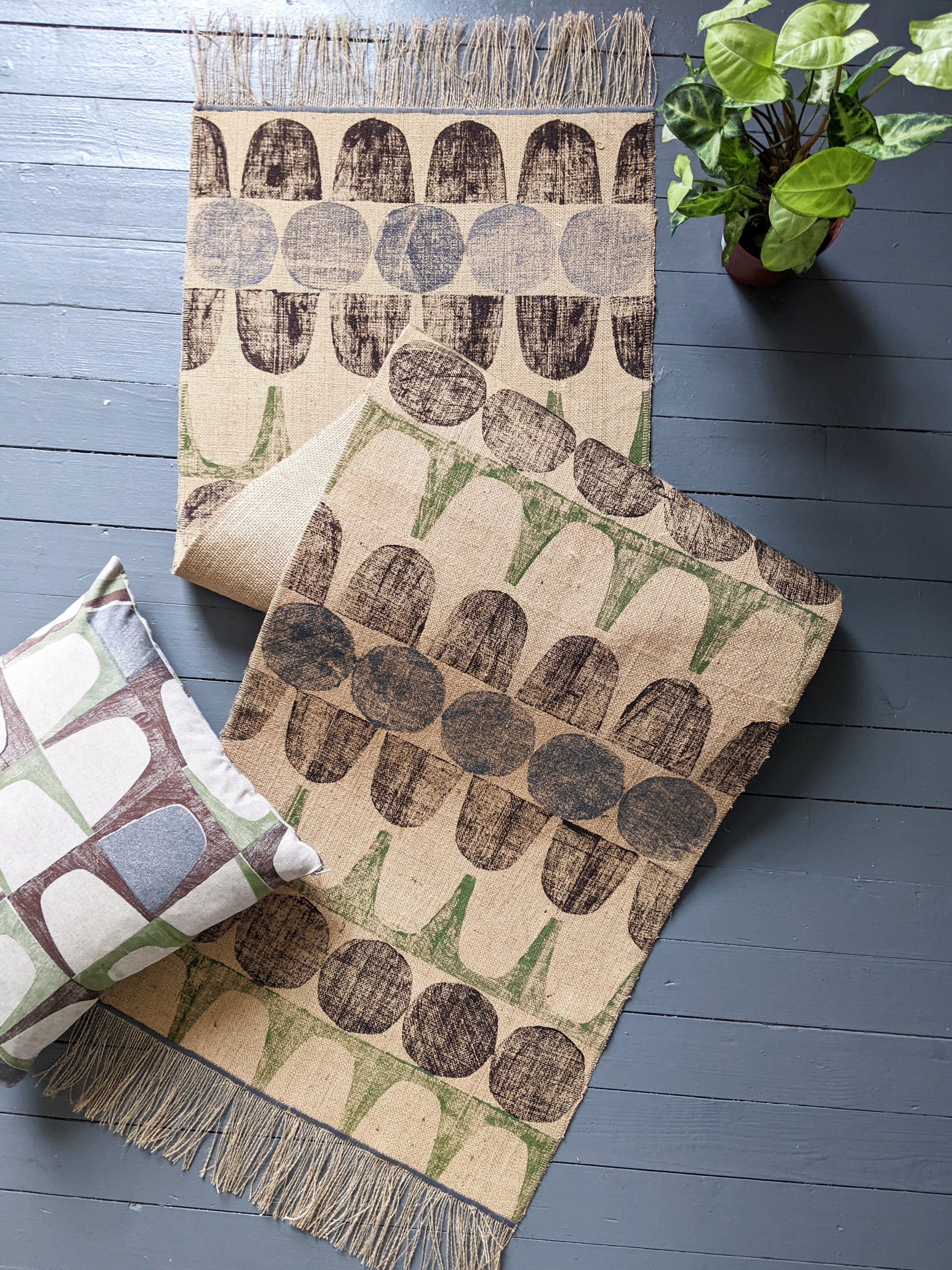 runner rug on floor with cushion and houseplant in grey and brown abstract geometric print