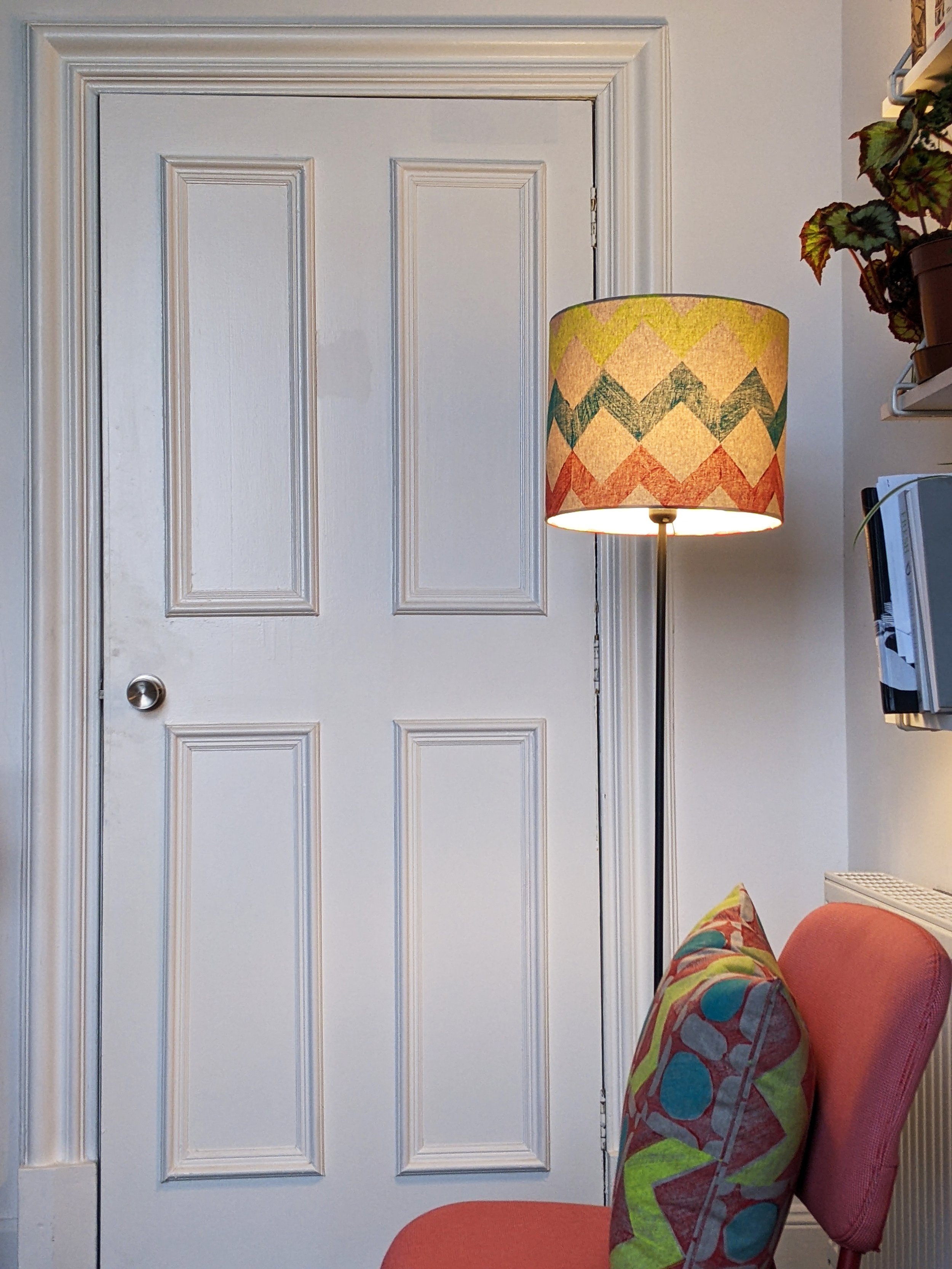 cosy scandinavian style interior with bold printed geometric drum lampshade in colourful geometric print
