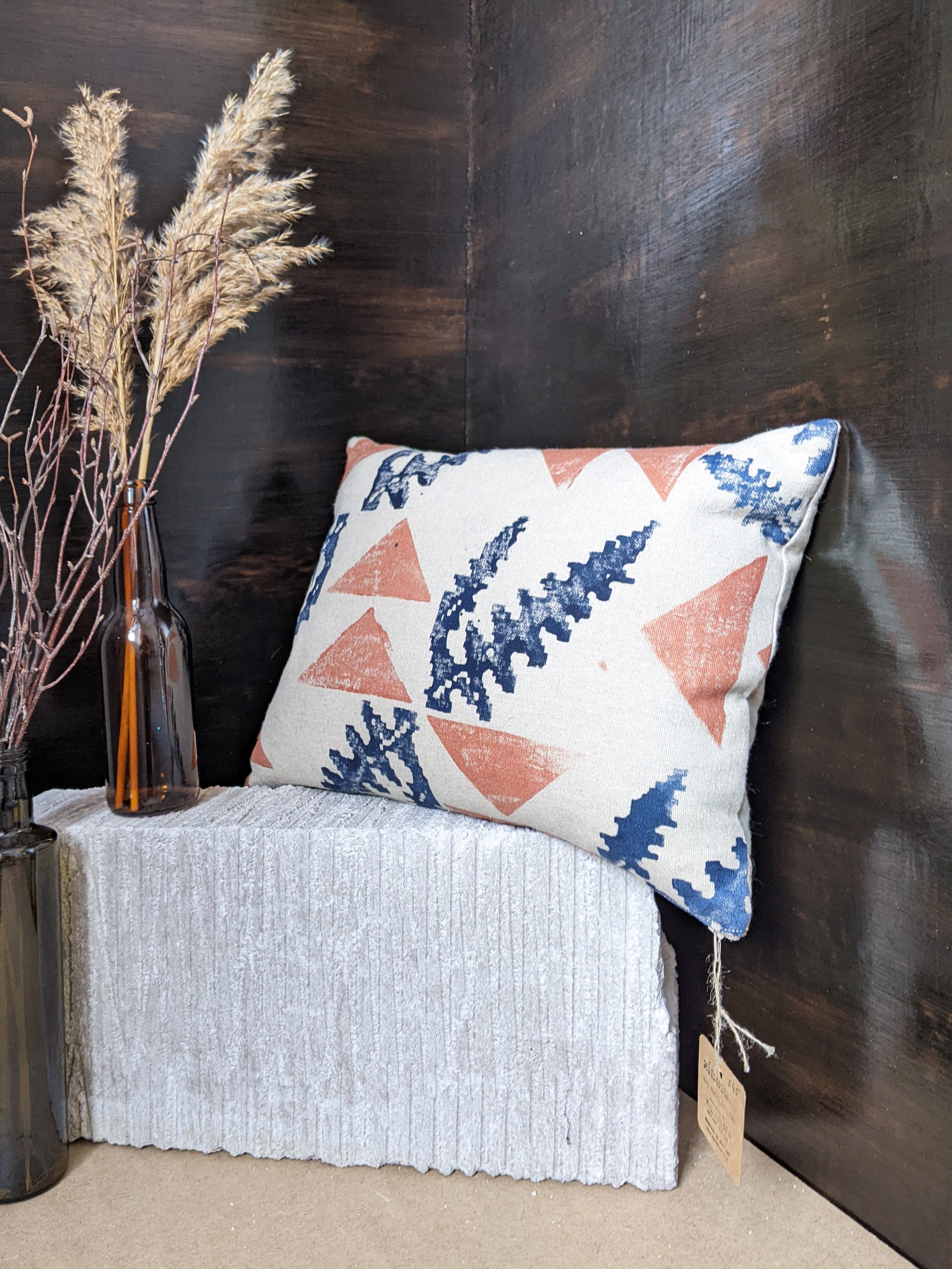 studio scene with rectangular cushion and dried flowers