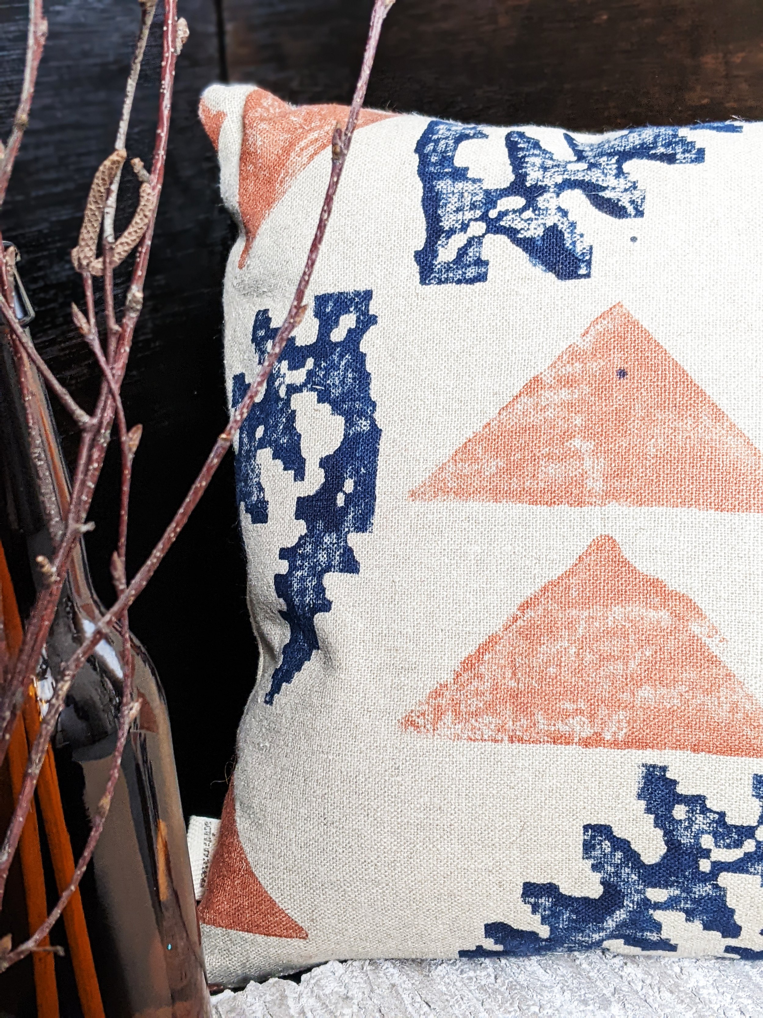 close-up detail of hand block printed cushion in rustic botanical minimalist pattern