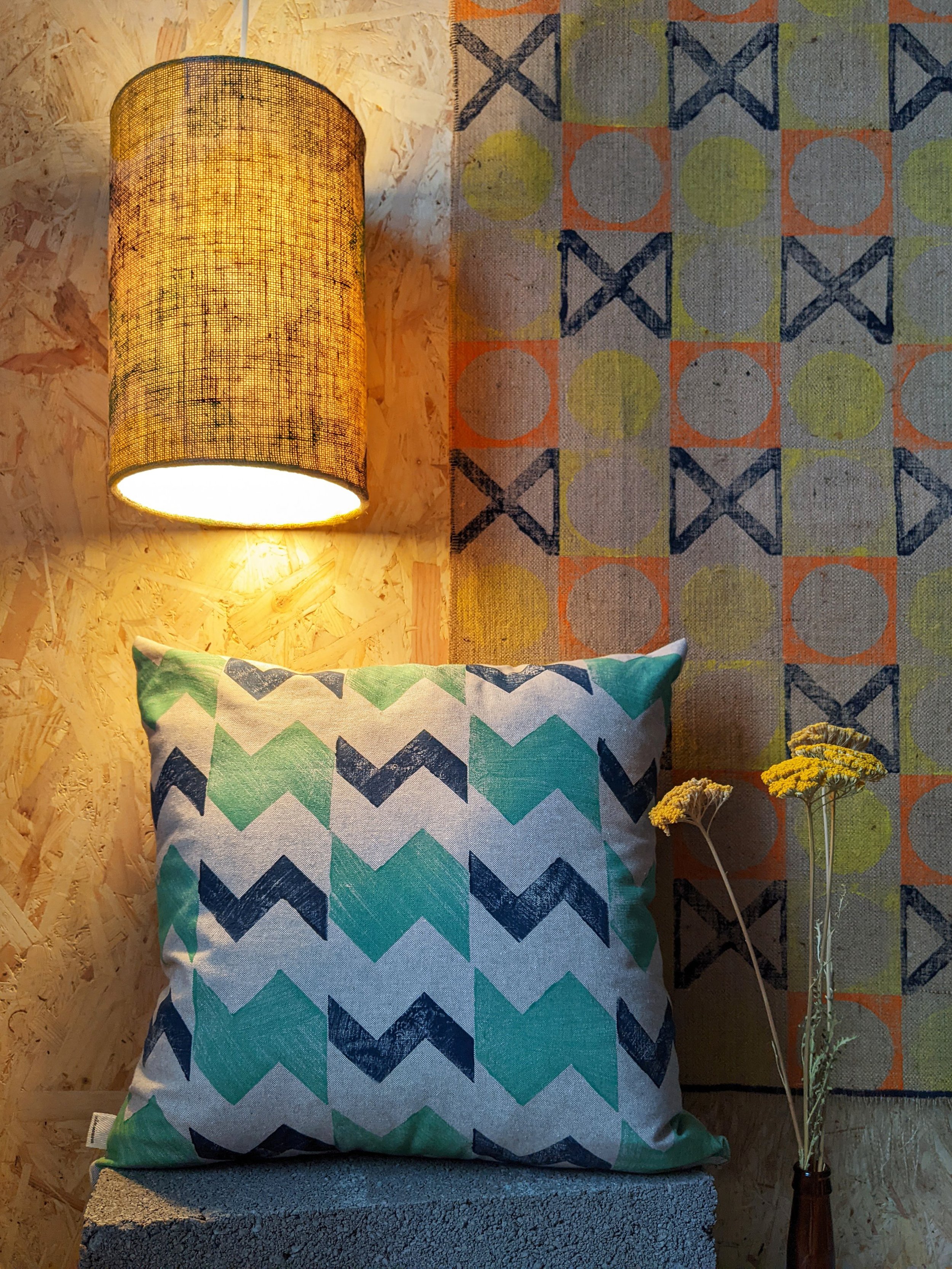 osy interior scene with illuminated light, rug and cushion in contemporary geometric patterns