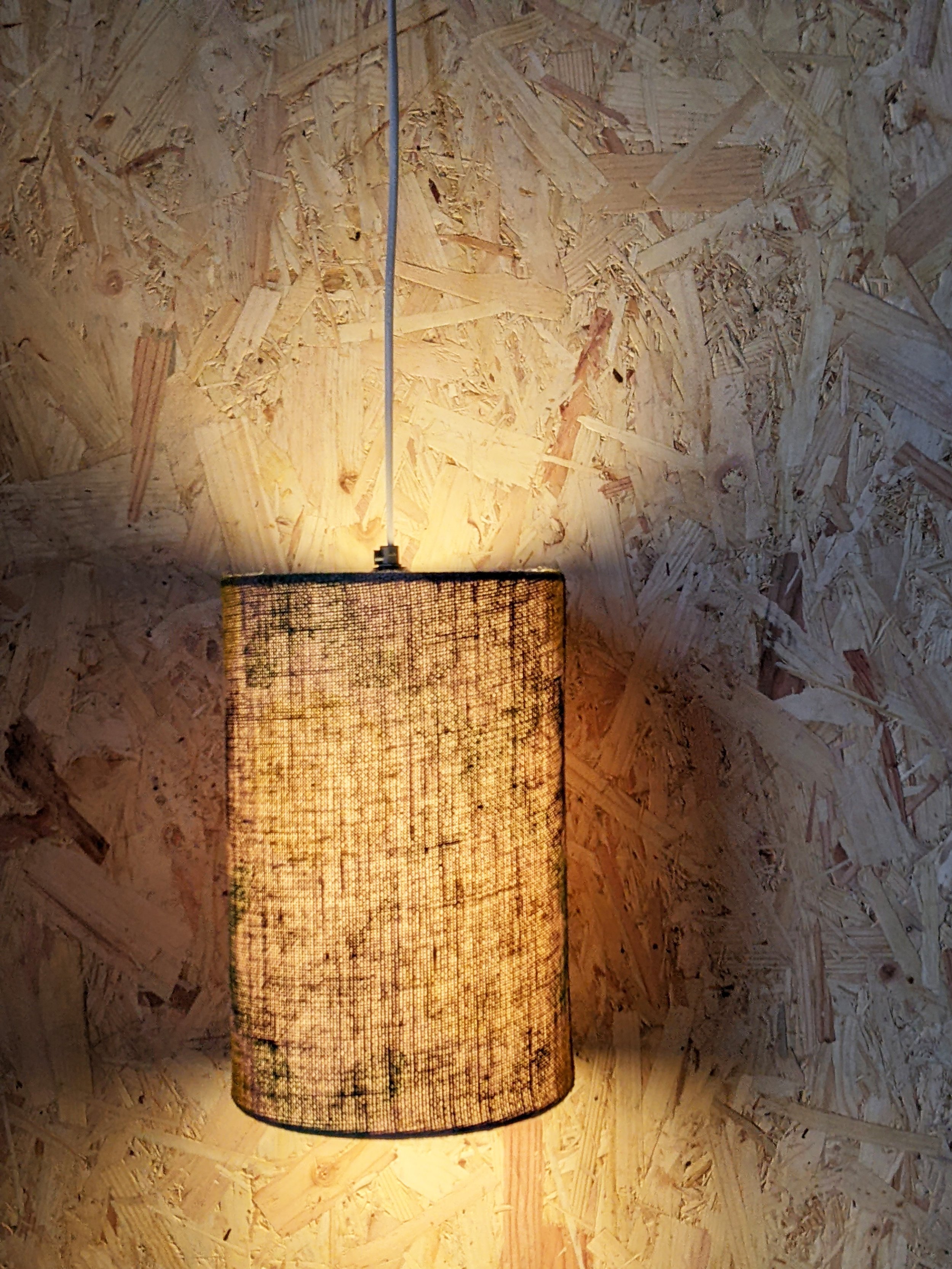 illuminated jute lamsphade on industrial background with texture showing