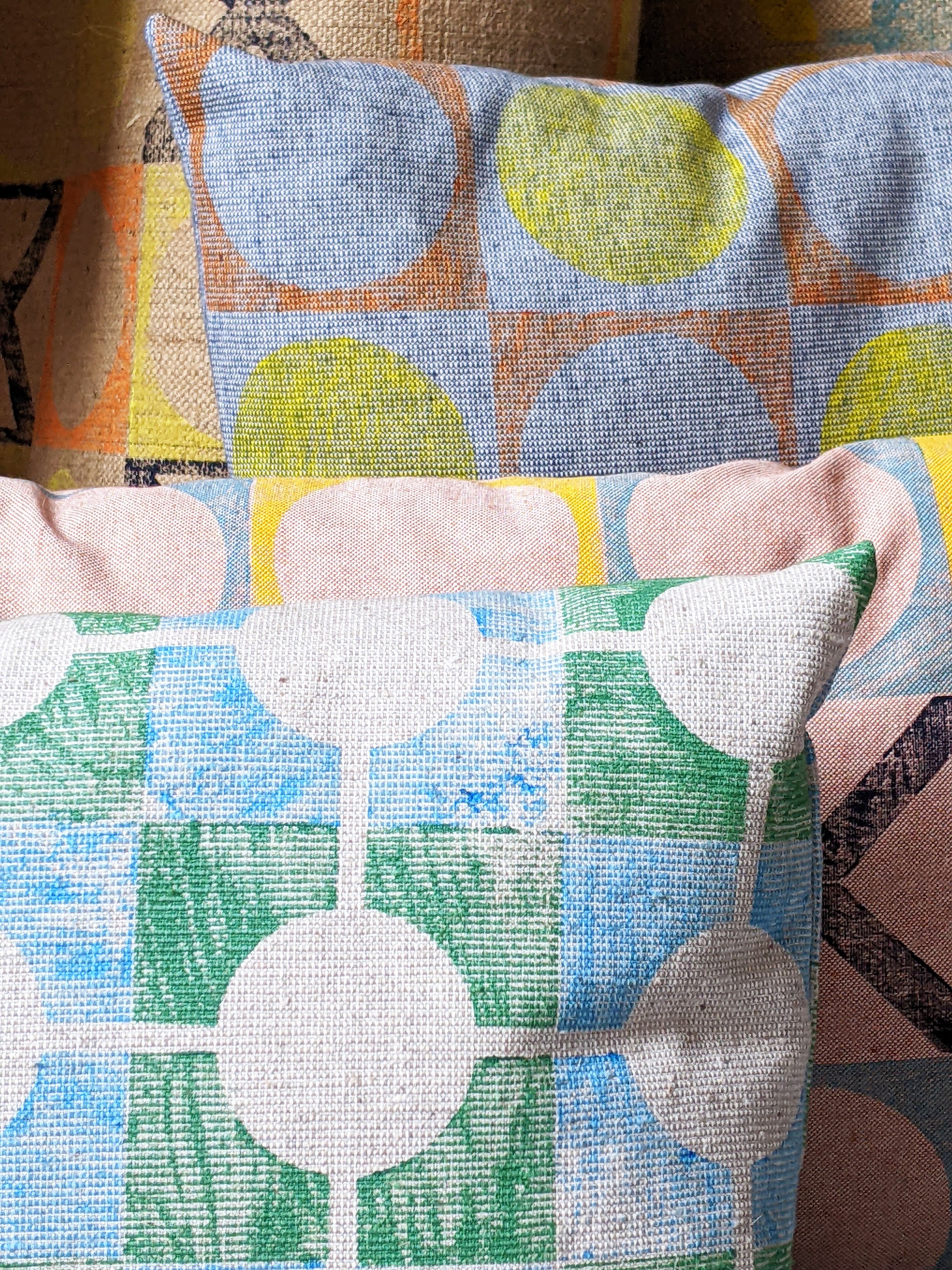 close-up detail of block printed patterns in bright colours on cushions