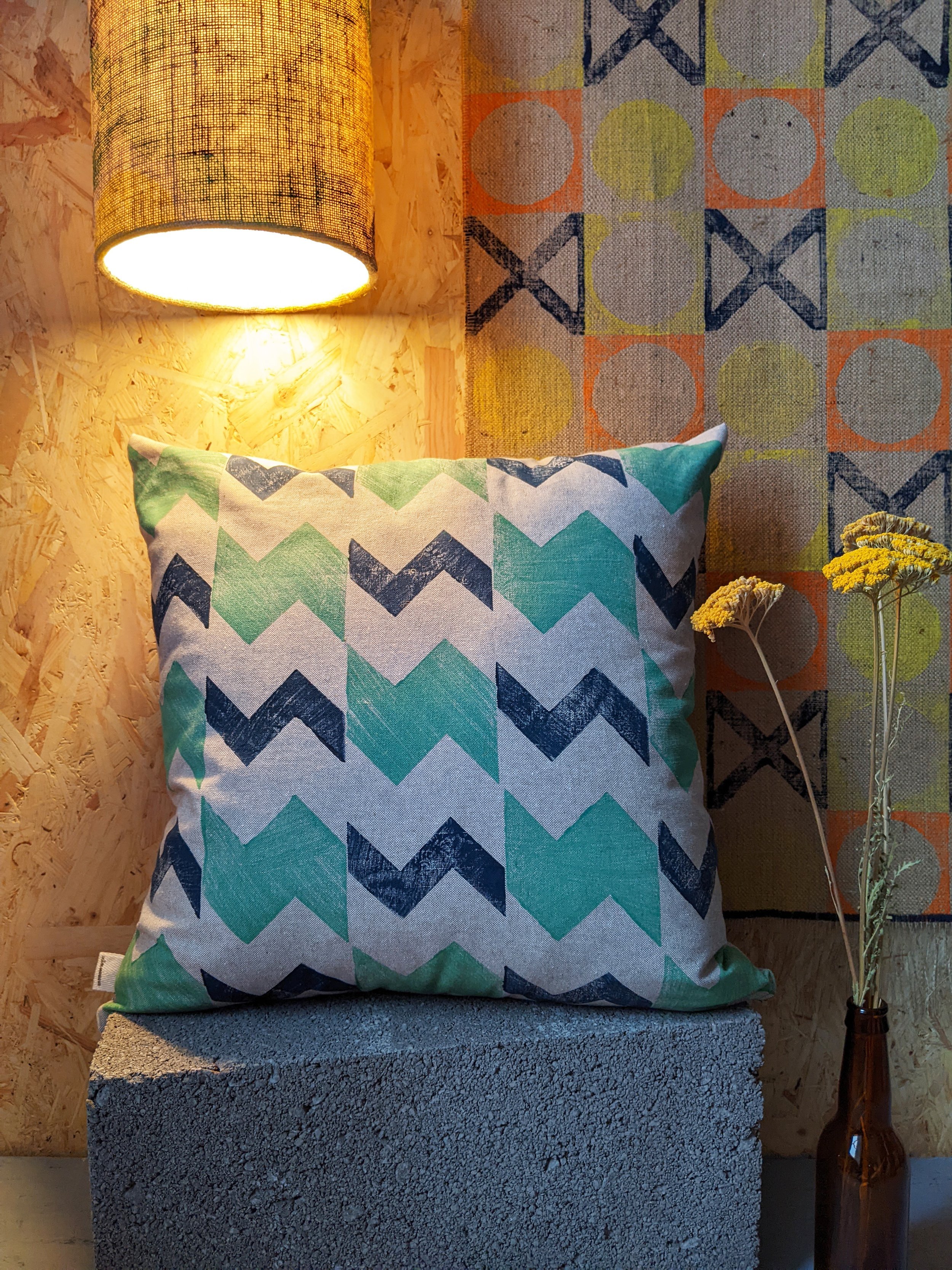 cosy contemporary interior scene with printed jute rug and abstract zig-zag printed cushions