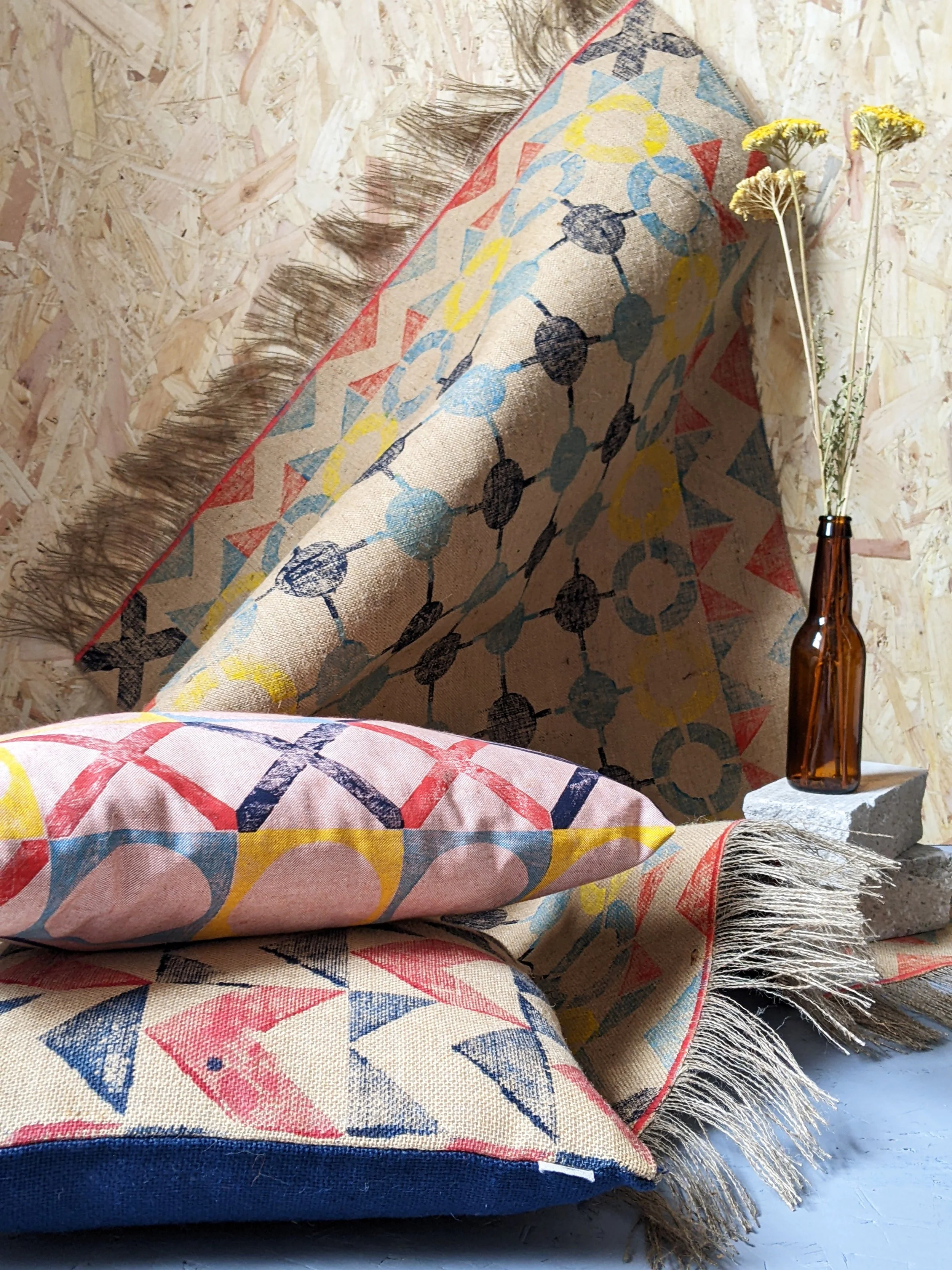 home textiles scene with nautical inspired hand block printed fabrics - cushions and rugs