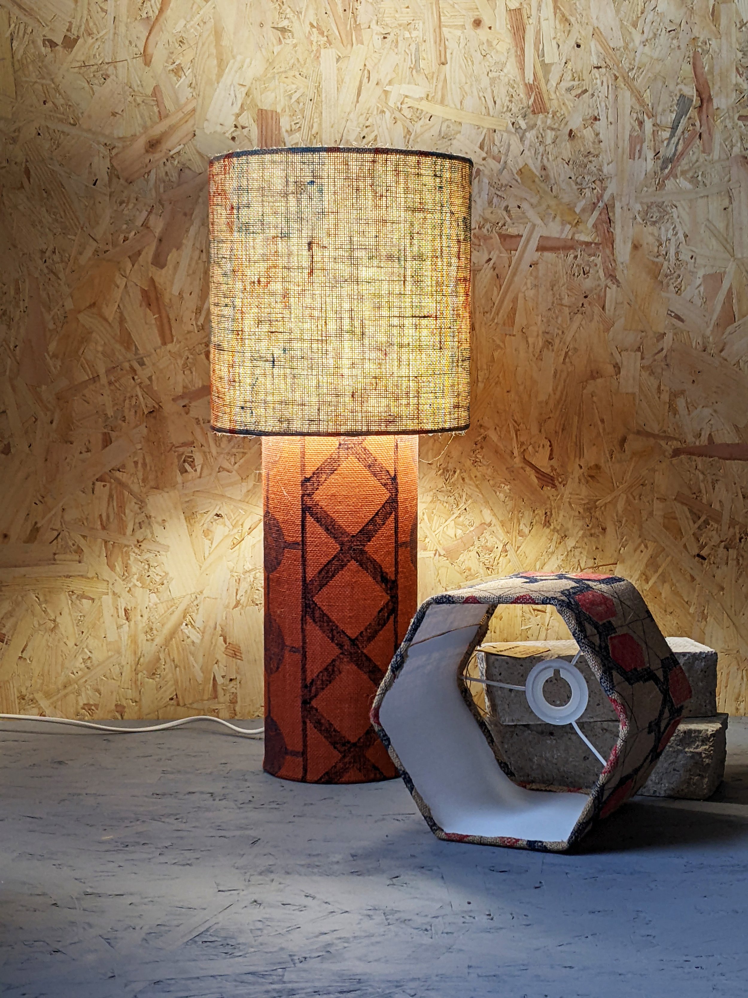 table lamp with terracotta industrial printed patterns illuminated in studio scene