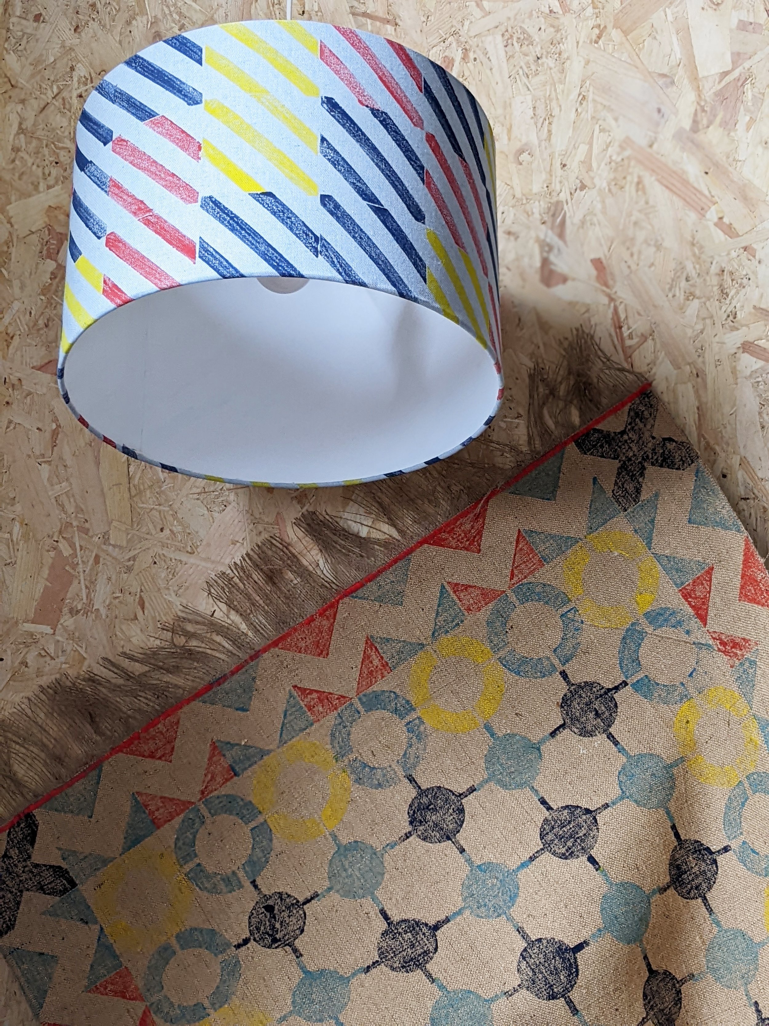 cosy studio scene with blue striped lampshade and bold nautical industrial inspired rug with zigzag border print