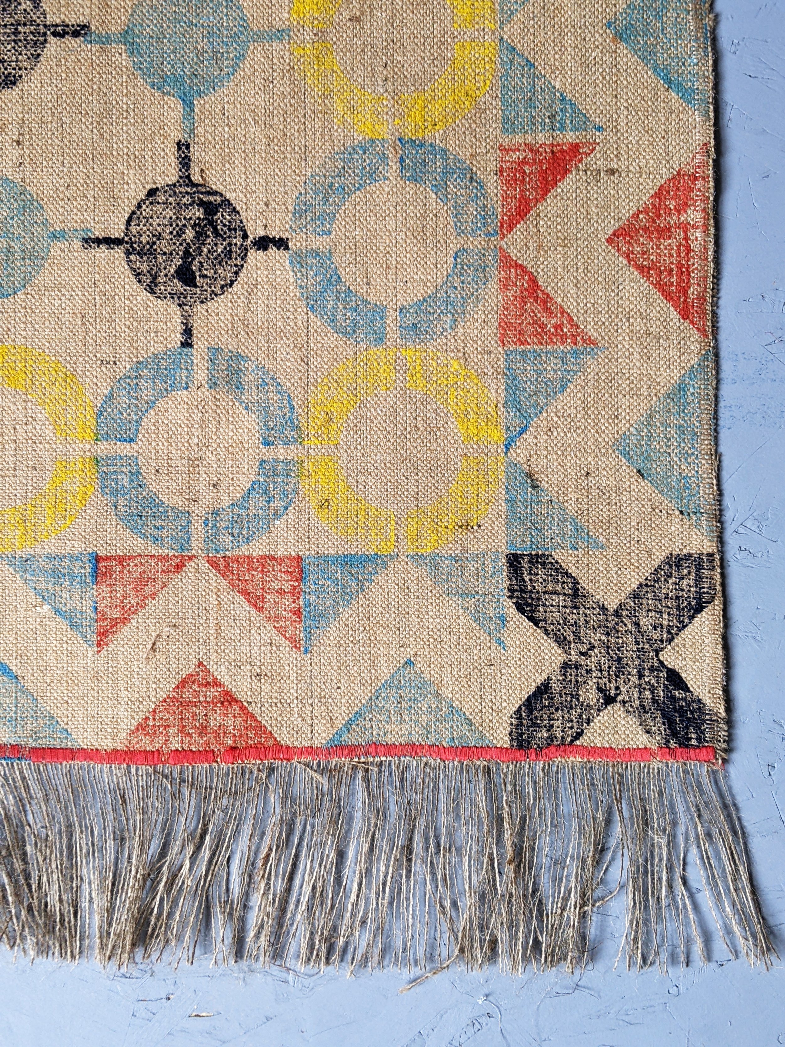 close-up detail of handmade block printed jute rug with nautical border print