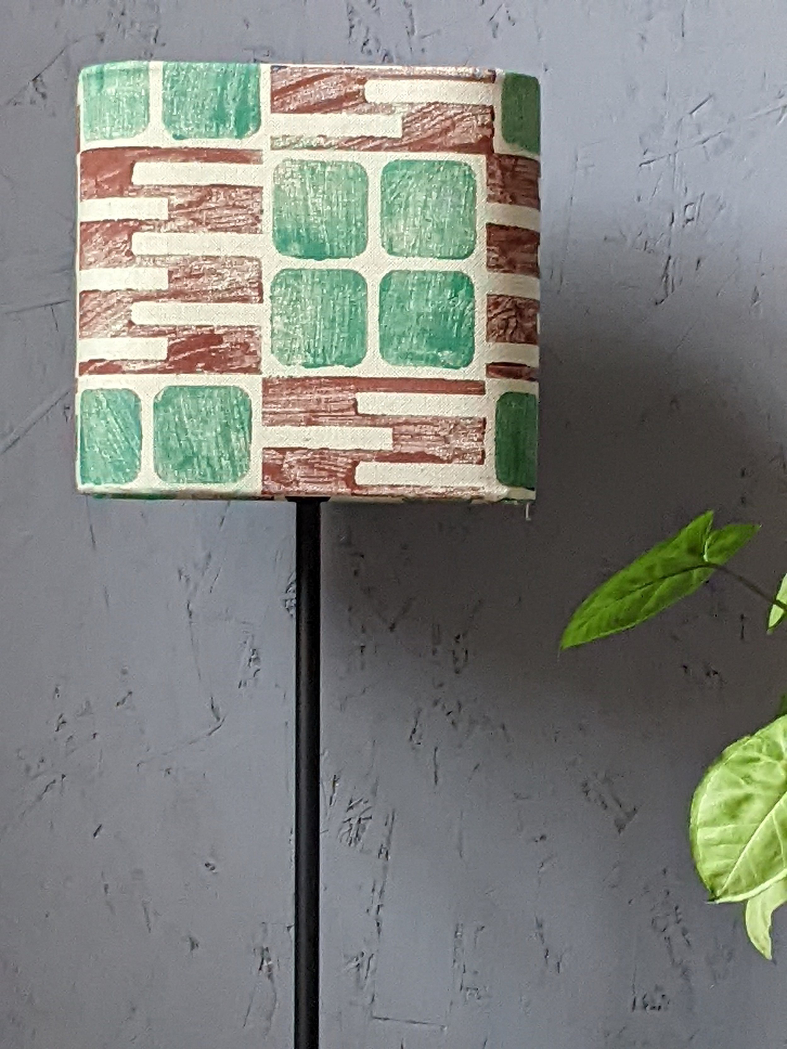 rounded square lampshade in block printed pattern in maroon and leaf green in brutalism-inspired print