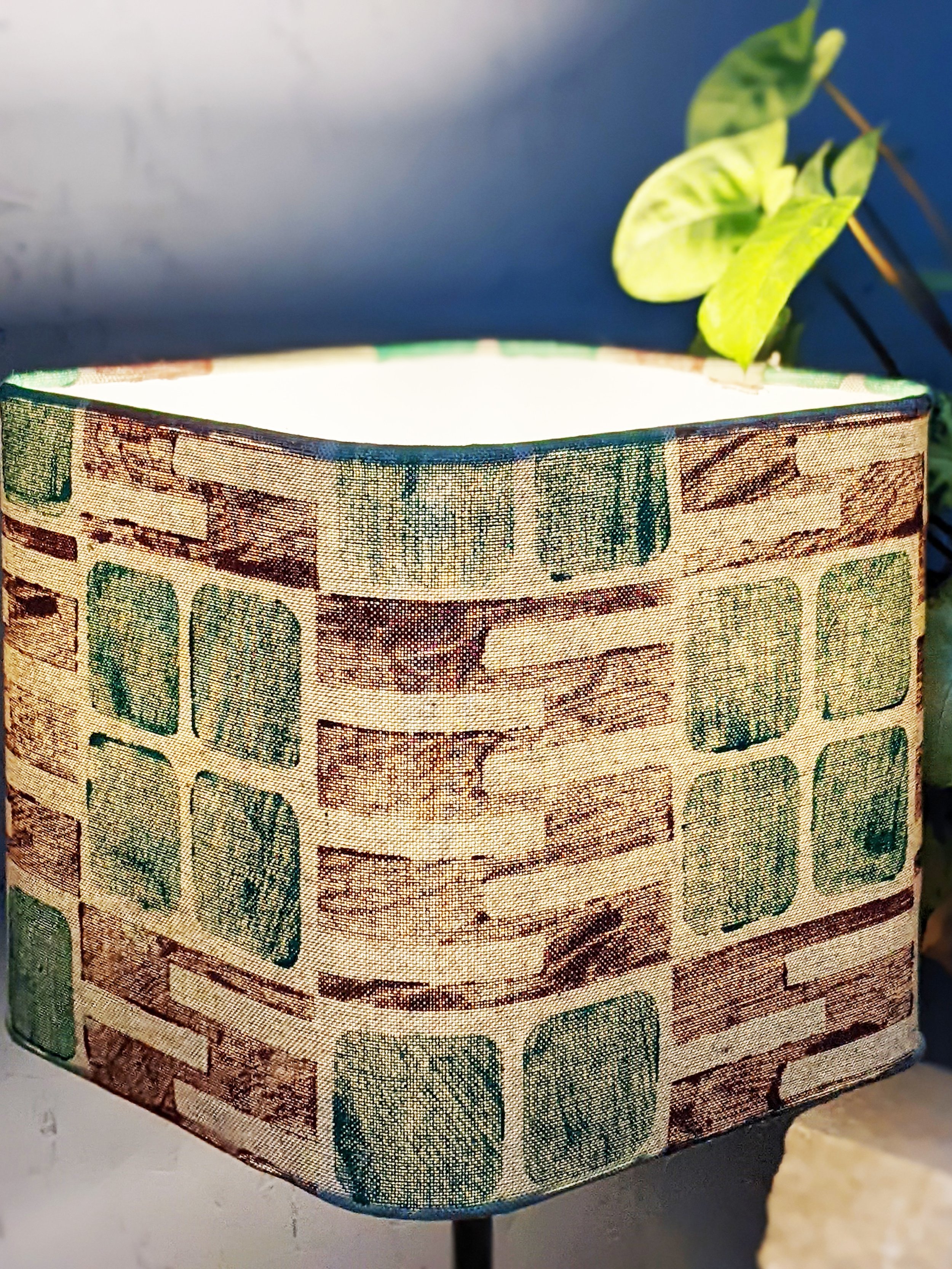 brutalism-inspired pattern in green and maroon on rounded square lampshade in sage cloth
