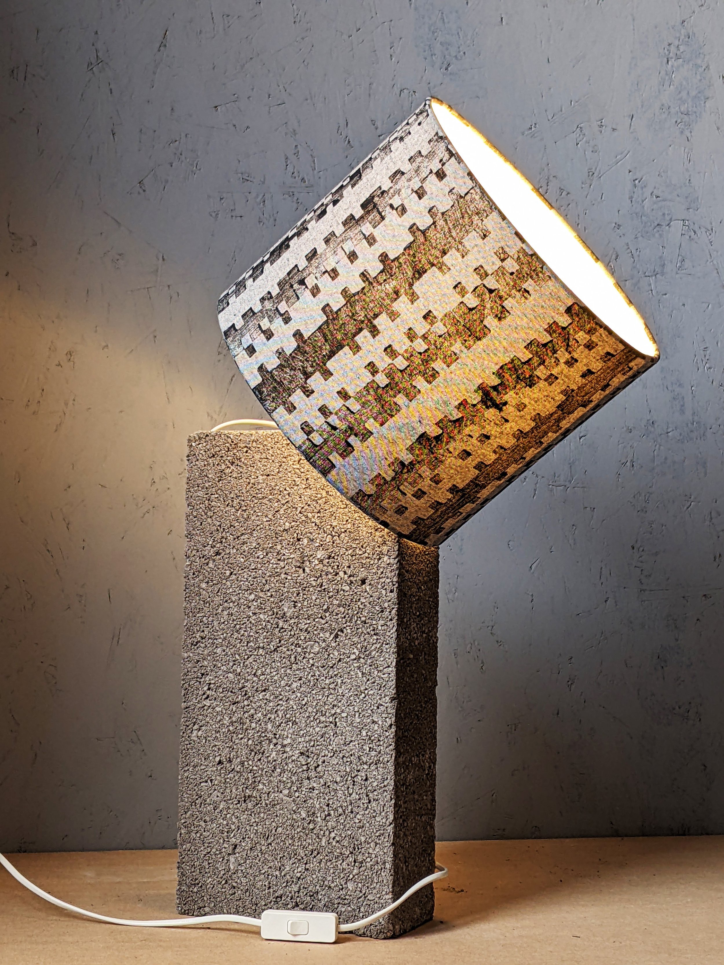 studio scene of brutalism inspired lampshade with concrete building block