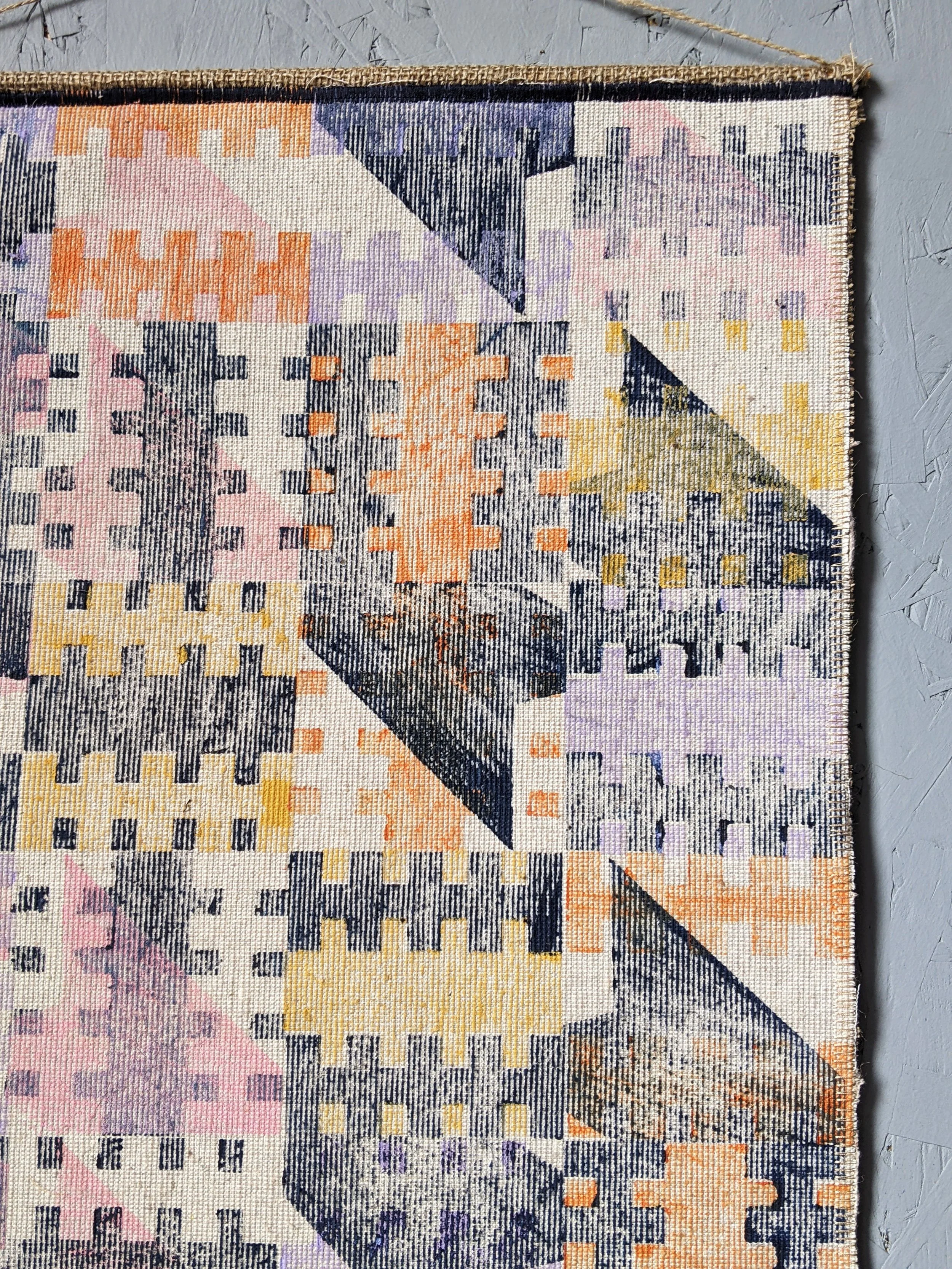 close-up details of wall hanging with dark navy and pastel colours inspired by modernist and brutalist architecture