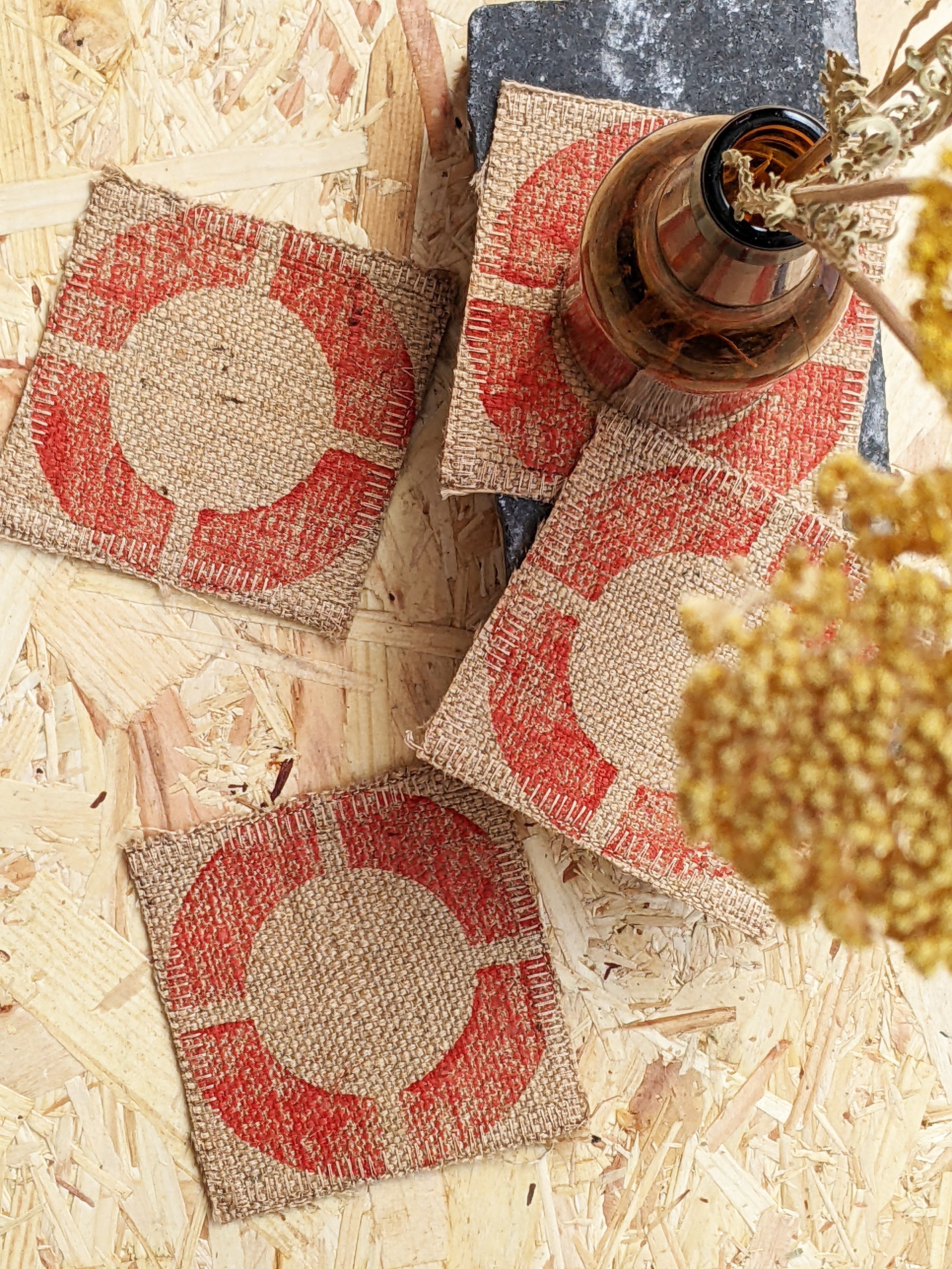 set of 4 jute coasters with red circular geometric print