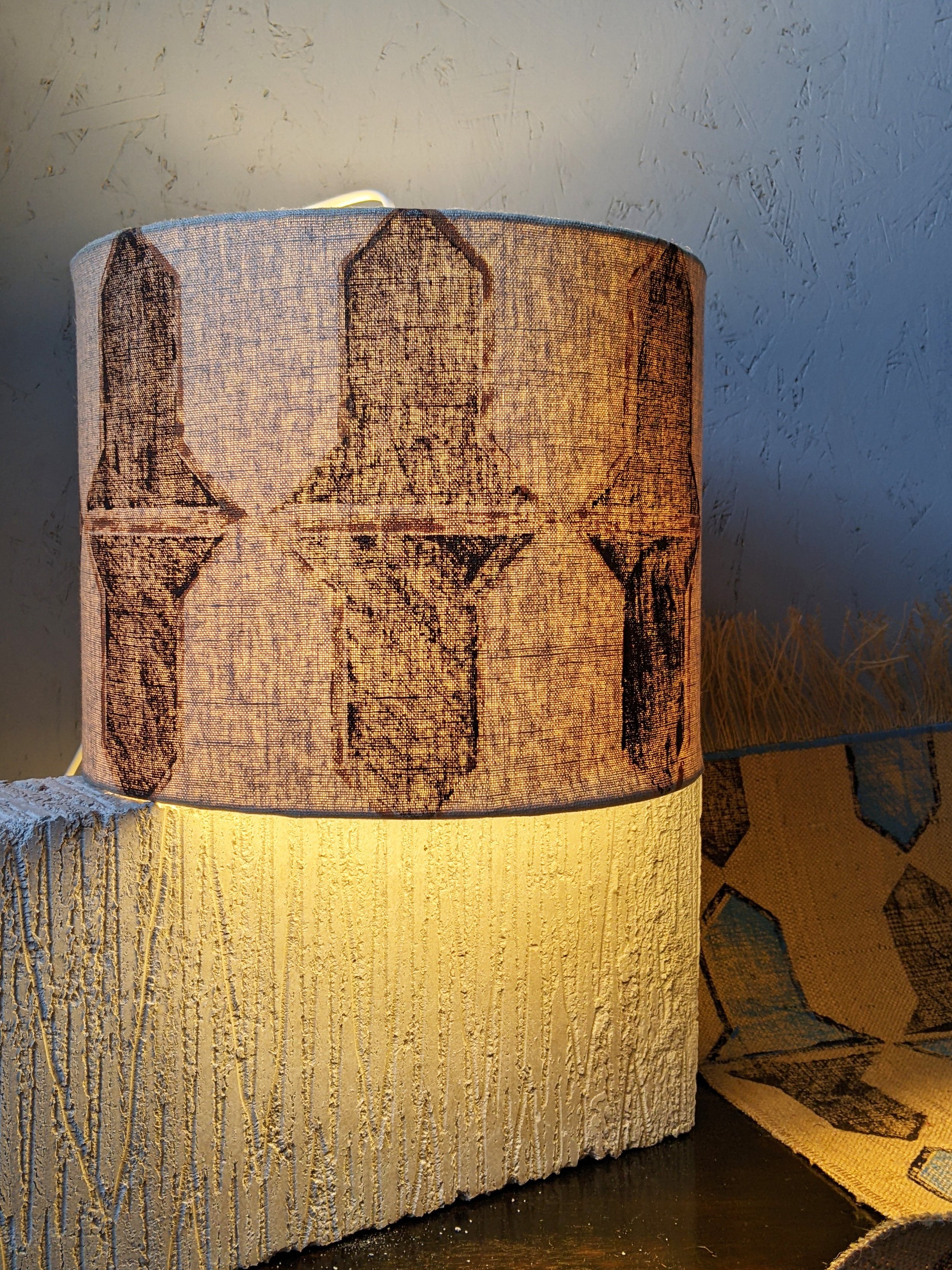 close-up detail of hand block printed abstract geometric pattern on illuminated lampshade