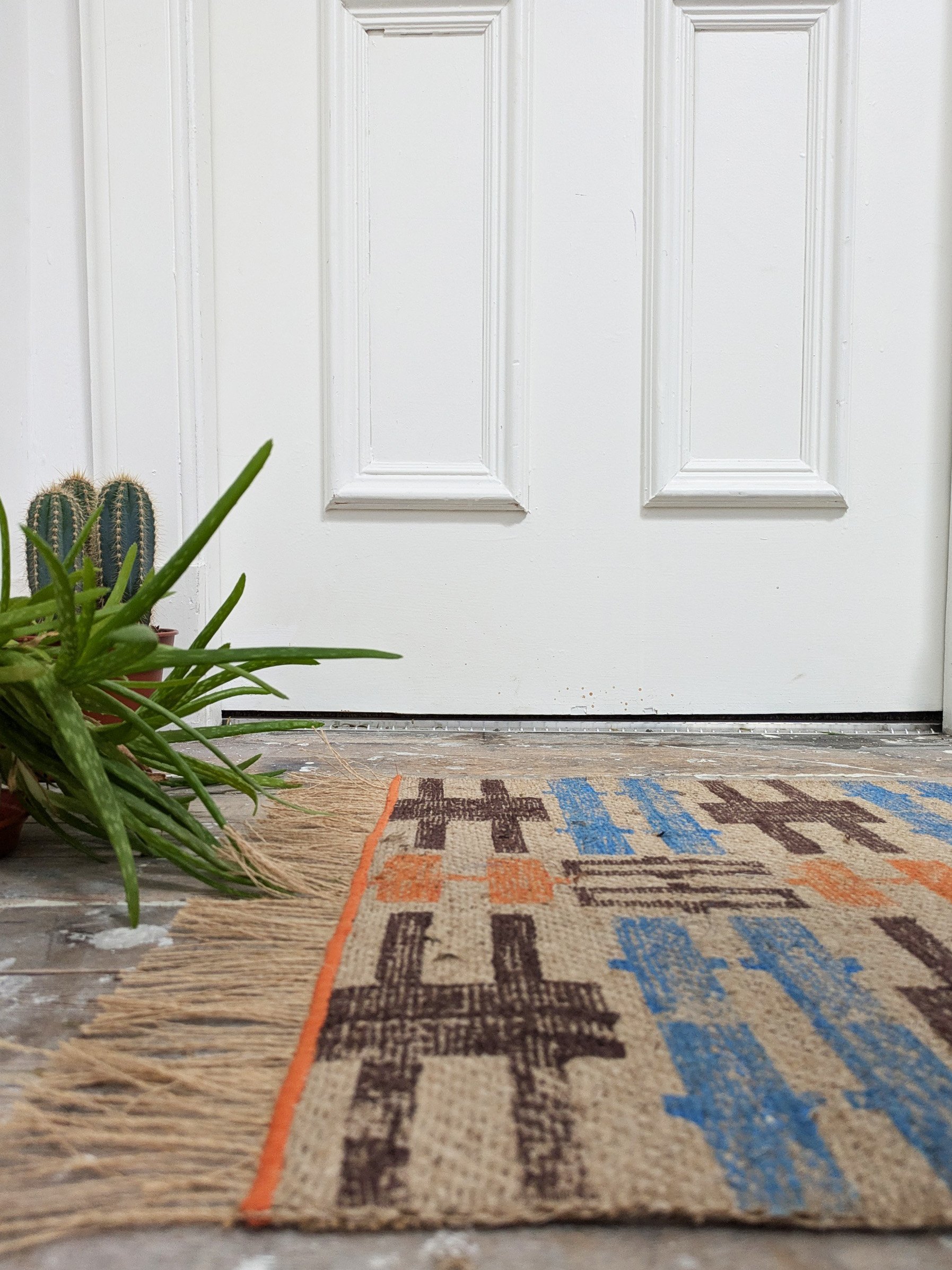 interior scene with warm textured jute rug in geometric contemporary print
