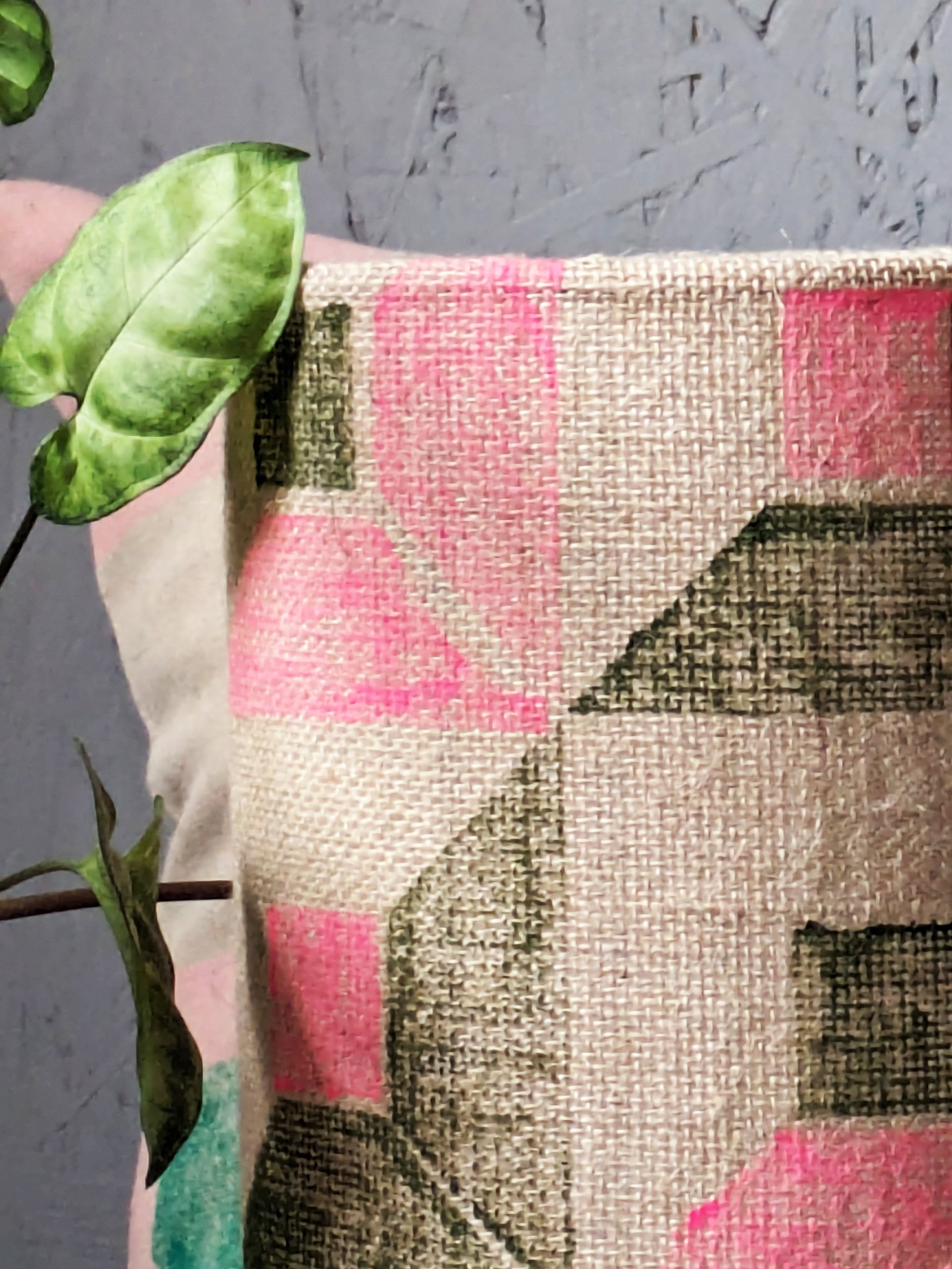 close-up detail of brutalism inspired geometric print on jute lampshade in neon pink and olive green