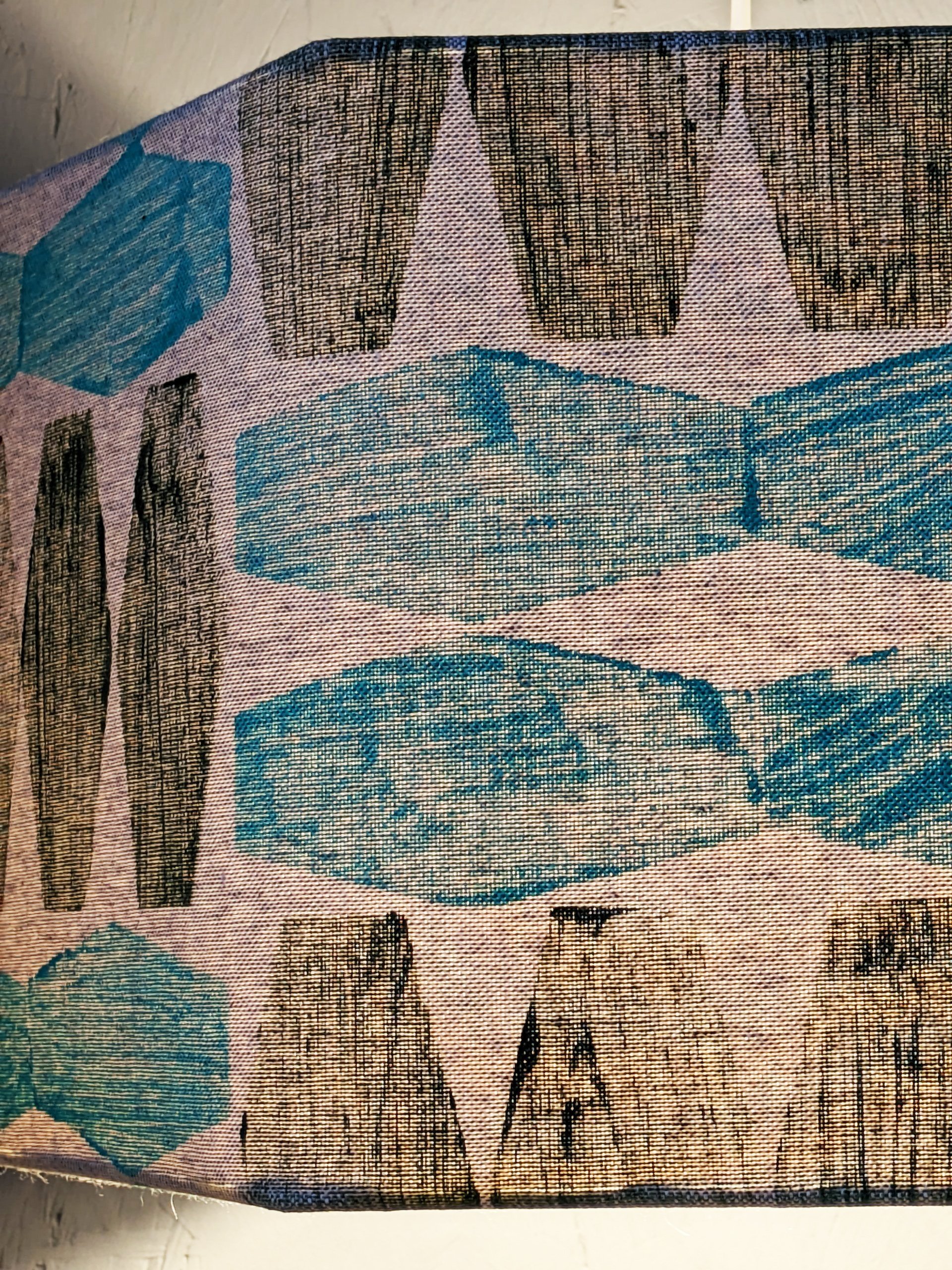 close-up details of lampshade with light in, with mint green and olive colours in contemporary brutalism inspired print
