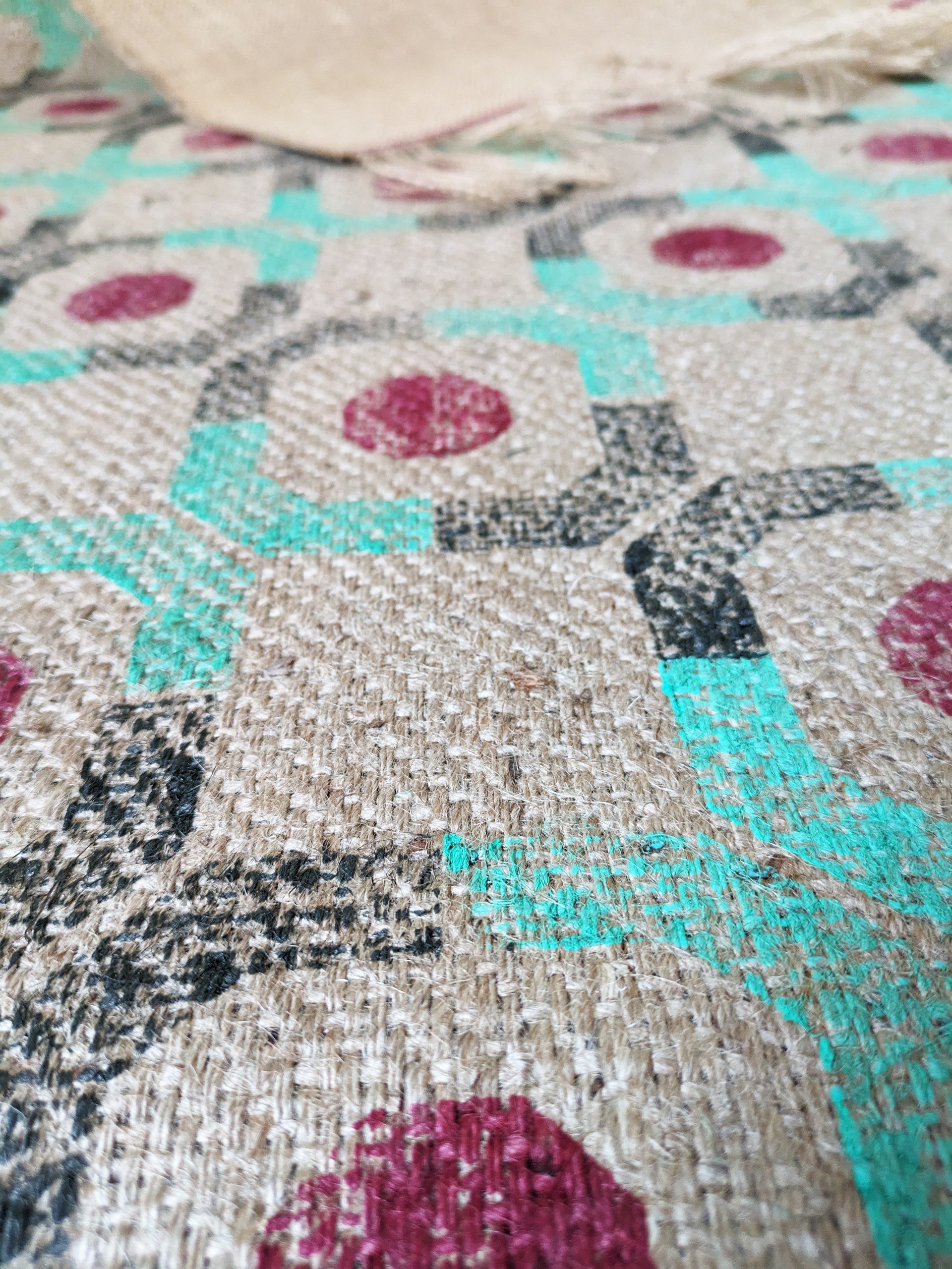 close-up detail of texture of heavyweight jute and hand block printed pattern on abstract geometric rug with modern architectural pattern