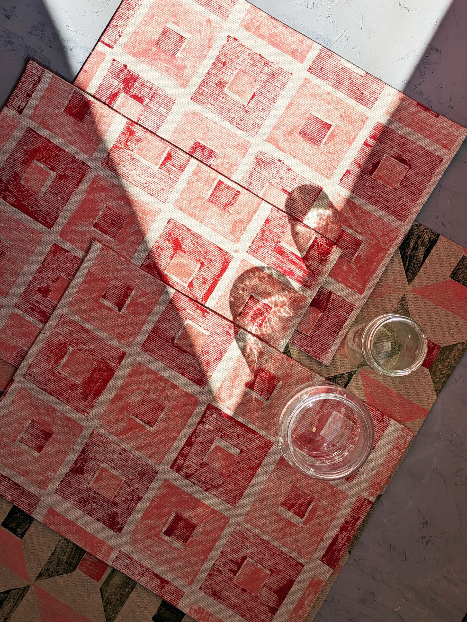 kitchen scene with textile place mat in hand printed check pattern in deep red and blossom pink