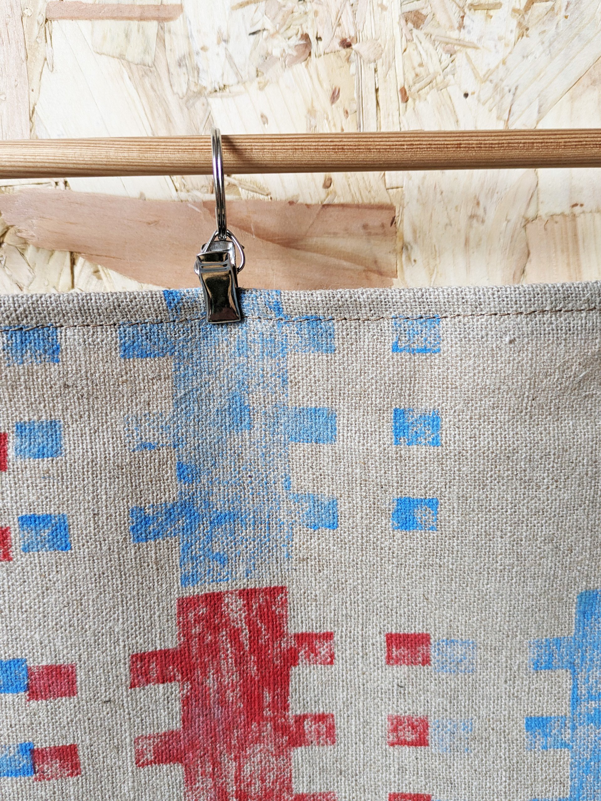 close-up detail of wall hanging with primary colours and modernist, architectural abstract print