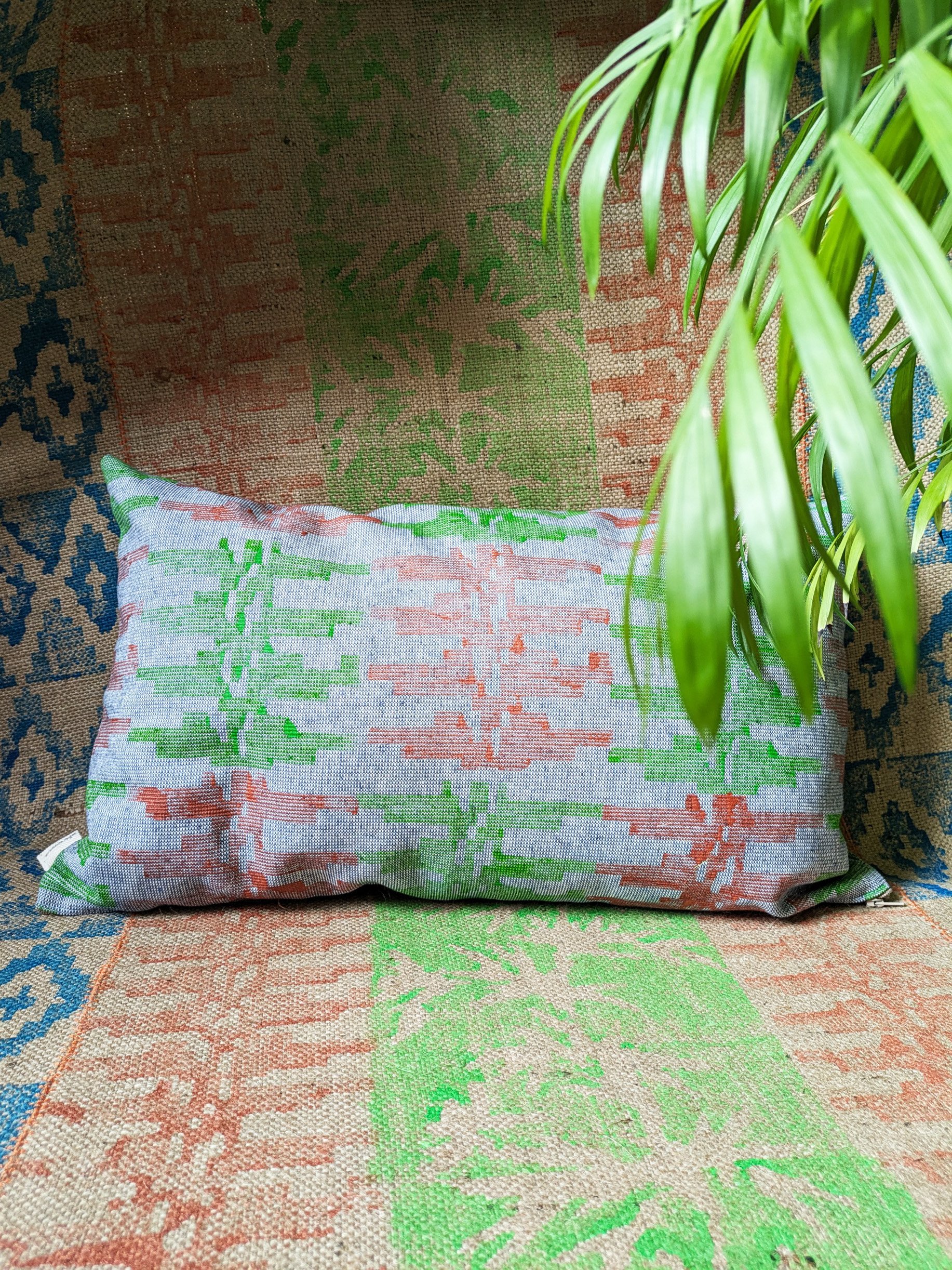 travel-inspired tribal print on rectangular cushion and jute rug in bright green, copper and blue