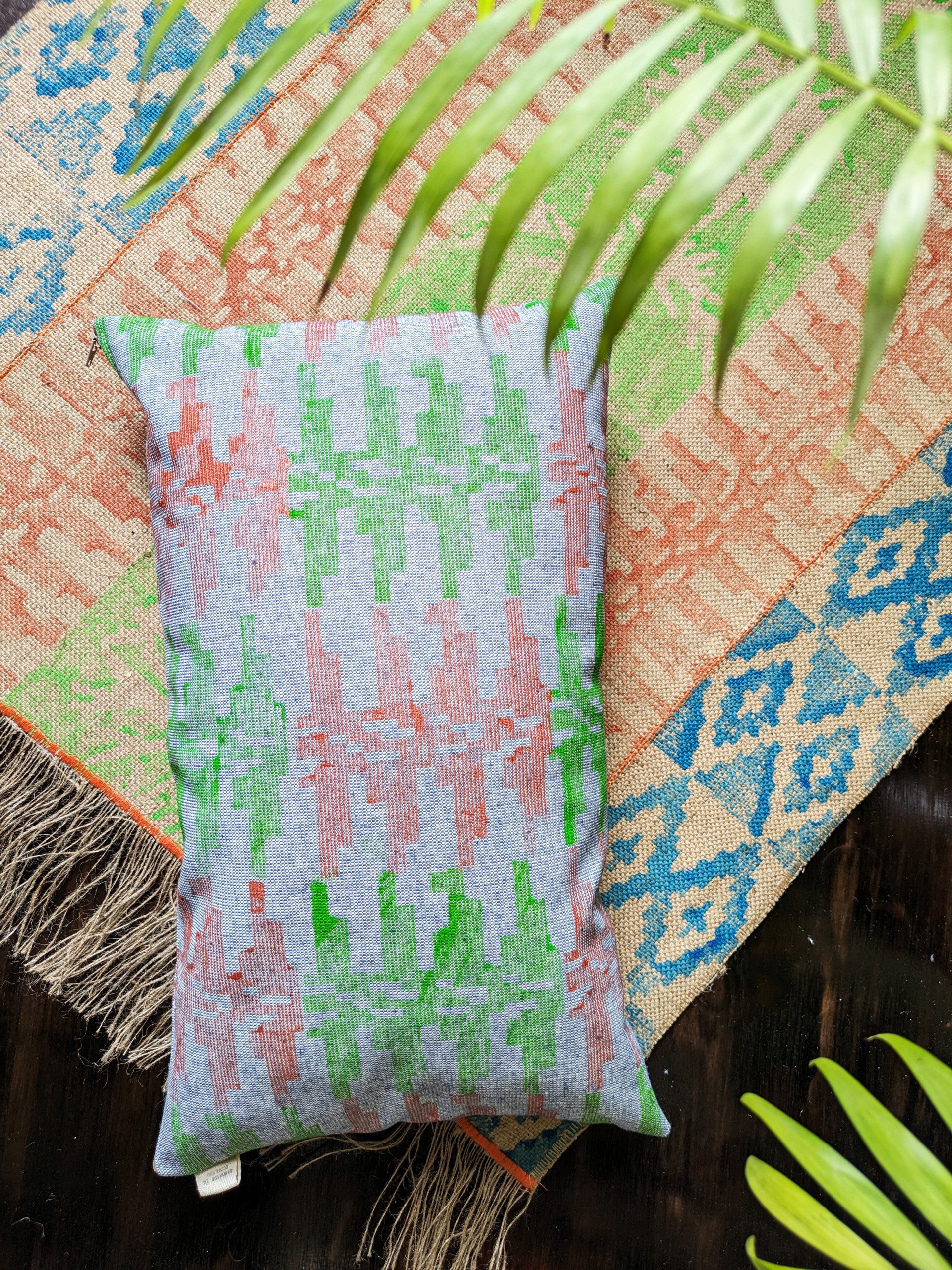 rectangular cushion in tribal-inspired pattern on printed jute rug