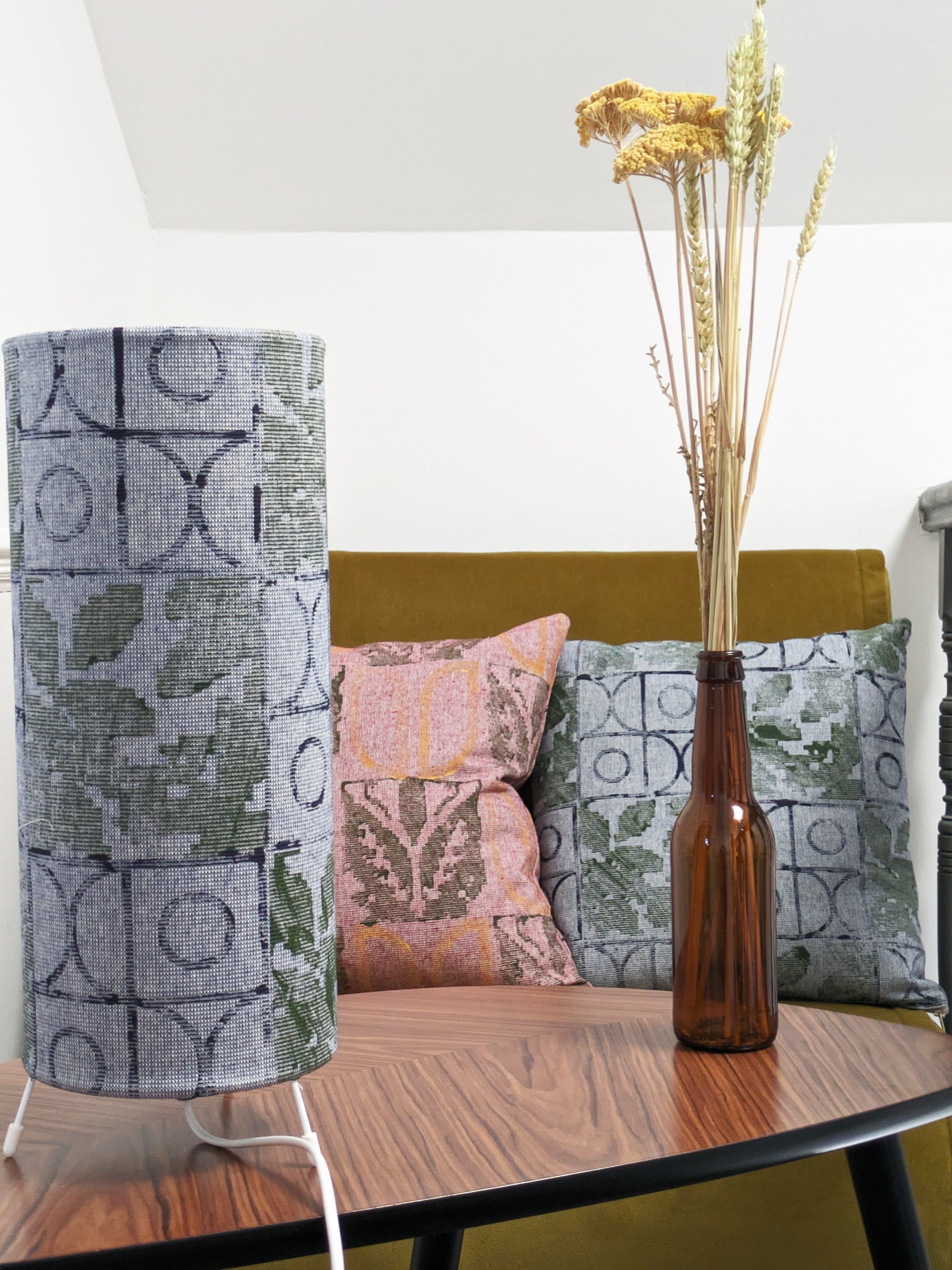 room set with small table lamp and cushions in tactile, hand printed patterns with folklore motifs