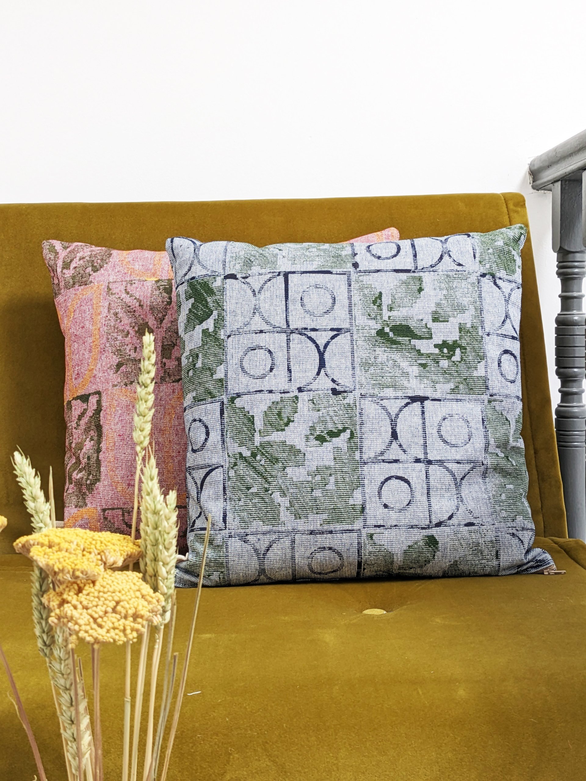 country style rustic block printed pattern on tactile cushion in olive and navy blue print