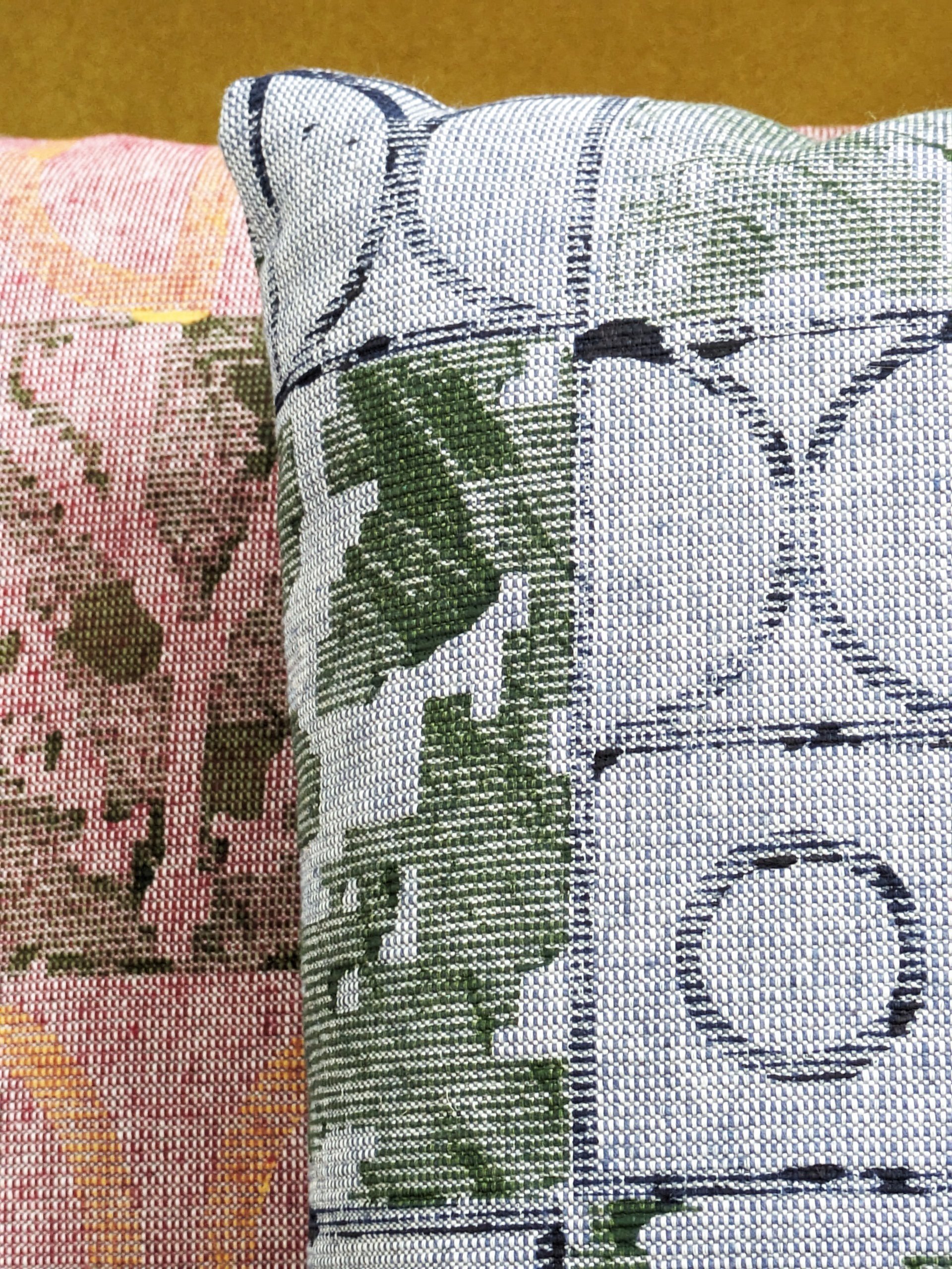 close-up detail of tactile rustic hand block printed pattern on blue textured cushion