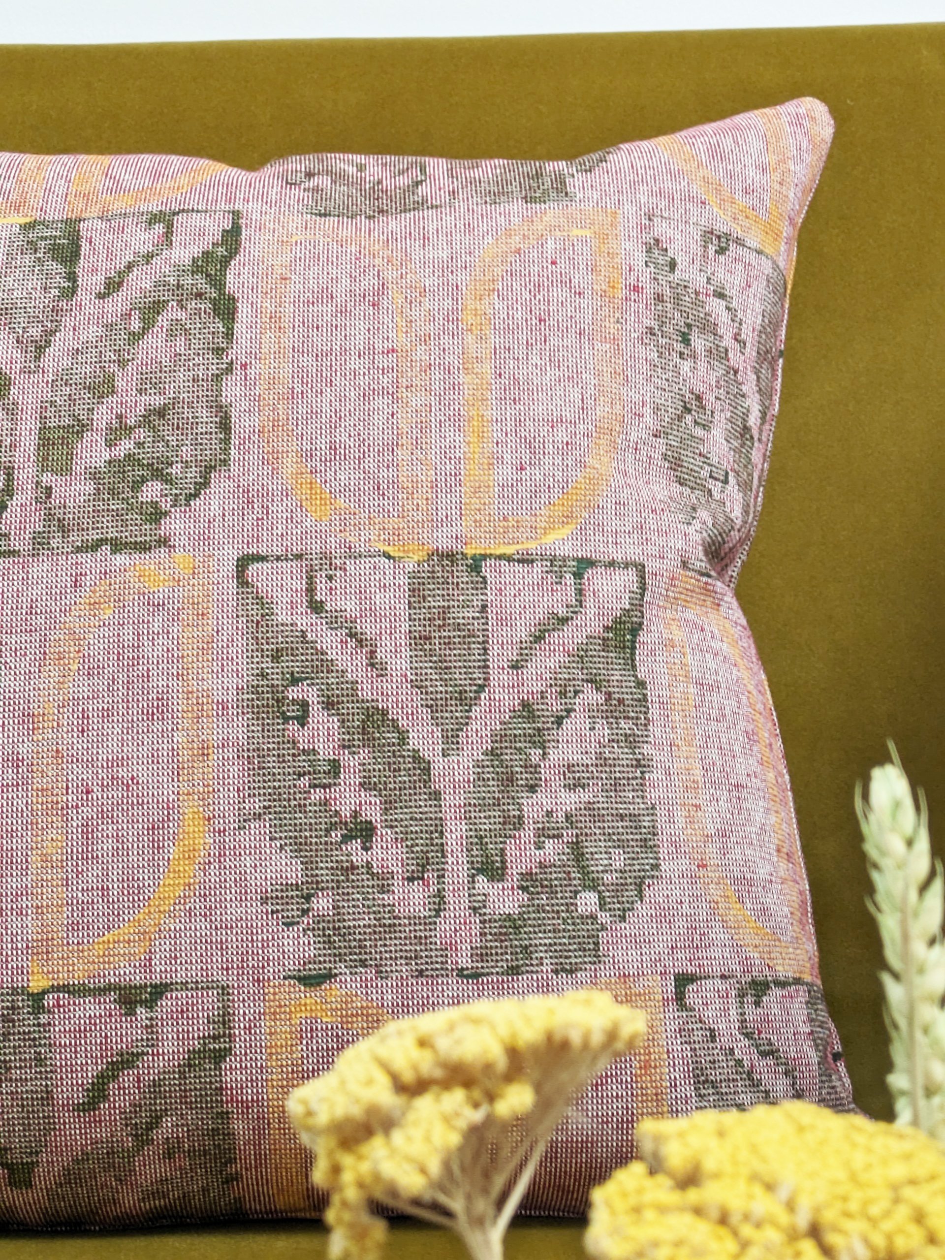 detail of hand block printed floral pattern in olive green and mustard yellow in boho rustic interior