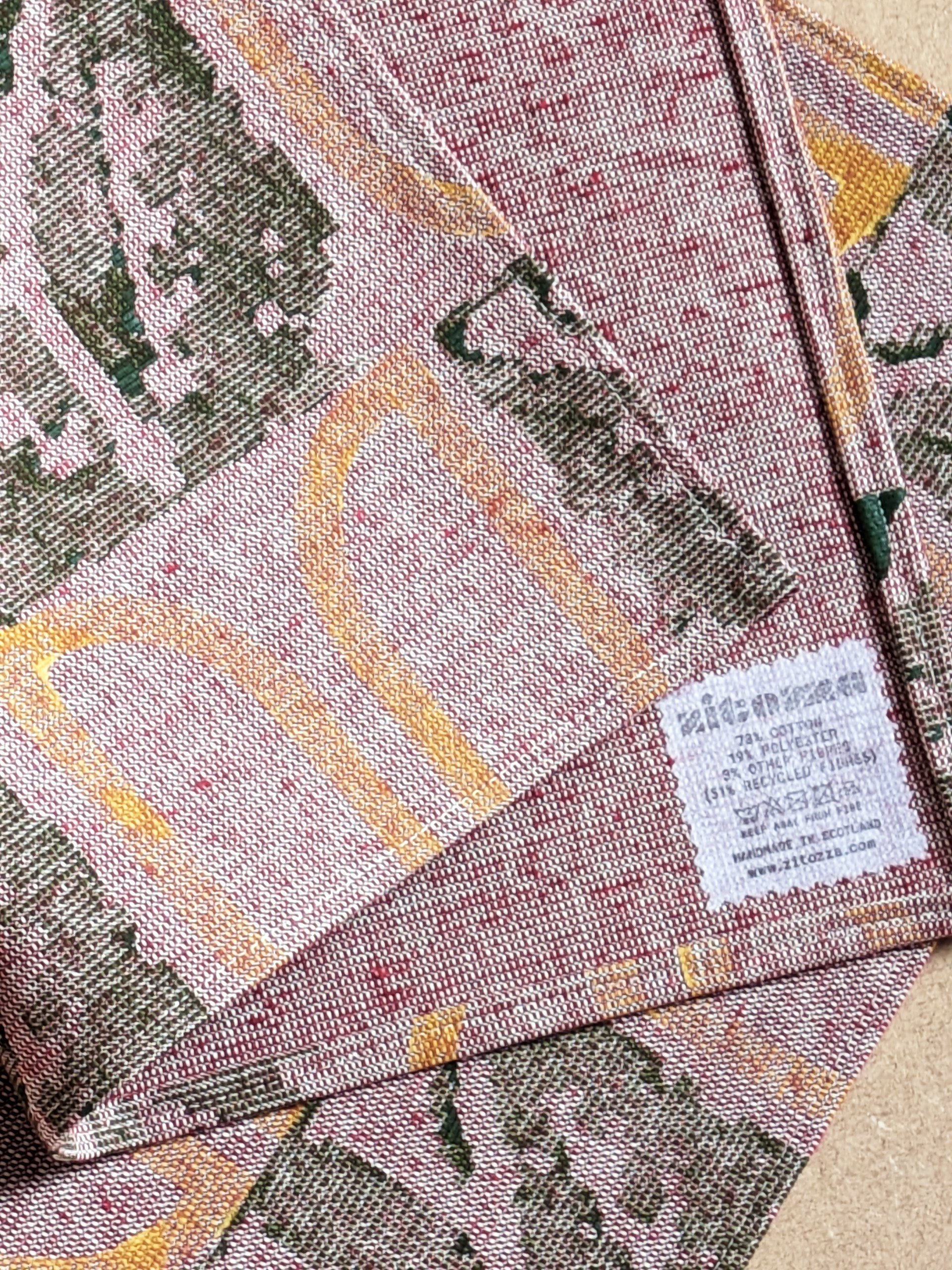 close-up detail of geometric rustic print in yellow and olive on tactile red place mats