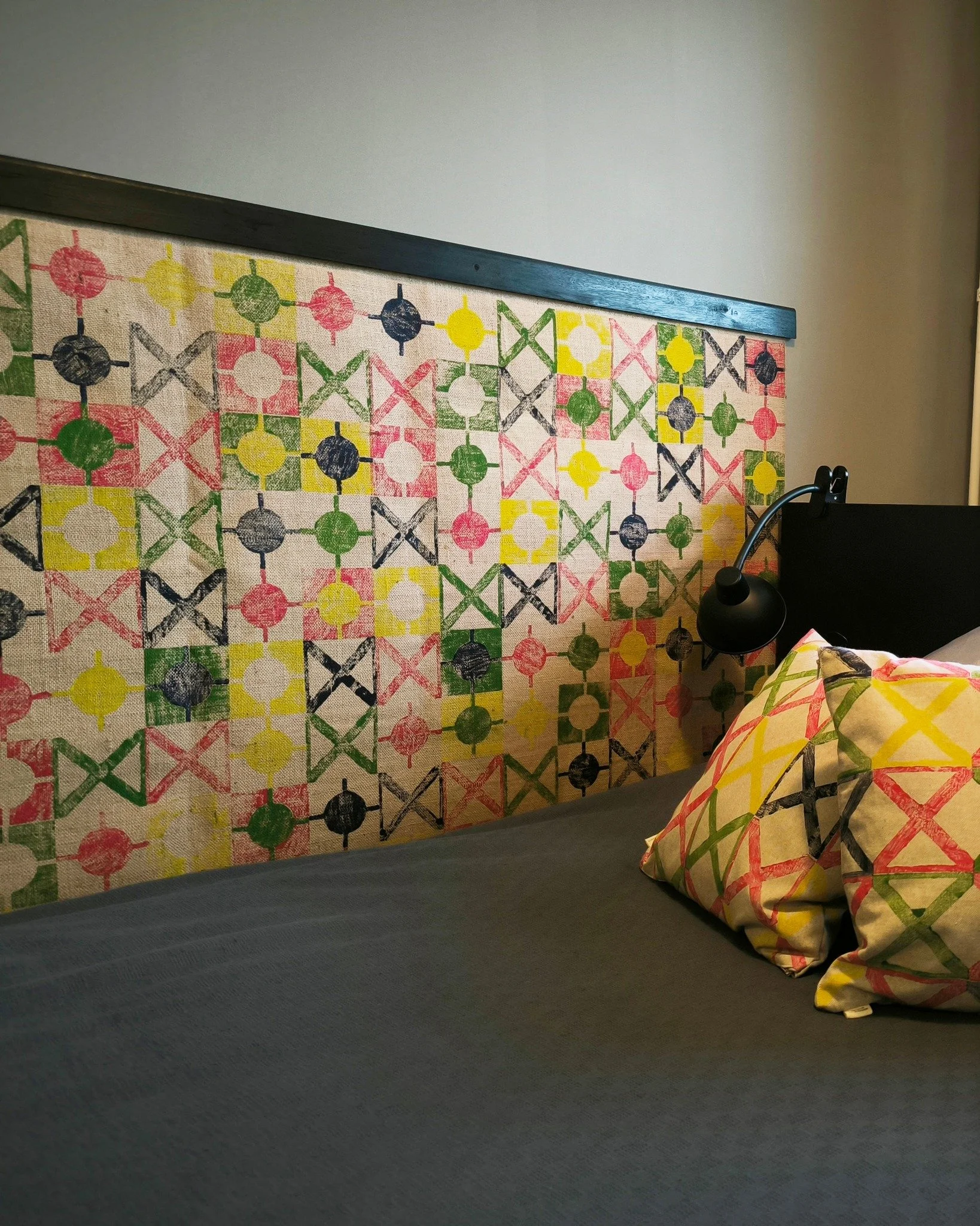 saturday at home 🛏️ rugs don&rsquo;t just belong underfoot. they can sit on a wall, catch the light, soften acoustics, and quietly reframe a room&rsquo;s geometry. cushions, prints, textiles: all doing their thing in a real interior. this was a besp