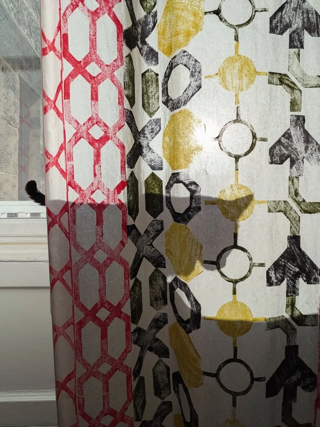 saturday at home ☀️ the sun is finally out and macska is on the hunt. one of the greatest pleasures of block printed curtains is how they change once the light hits them properly. 

the grid is no longer just ink on cloth, it becomes a screen for wha