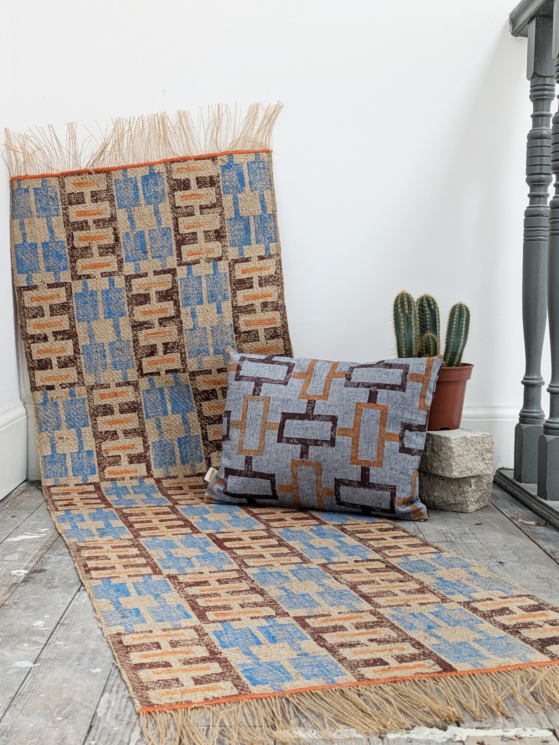 modern interior with cushion and rug in contemporary geometric hand block printed retro design